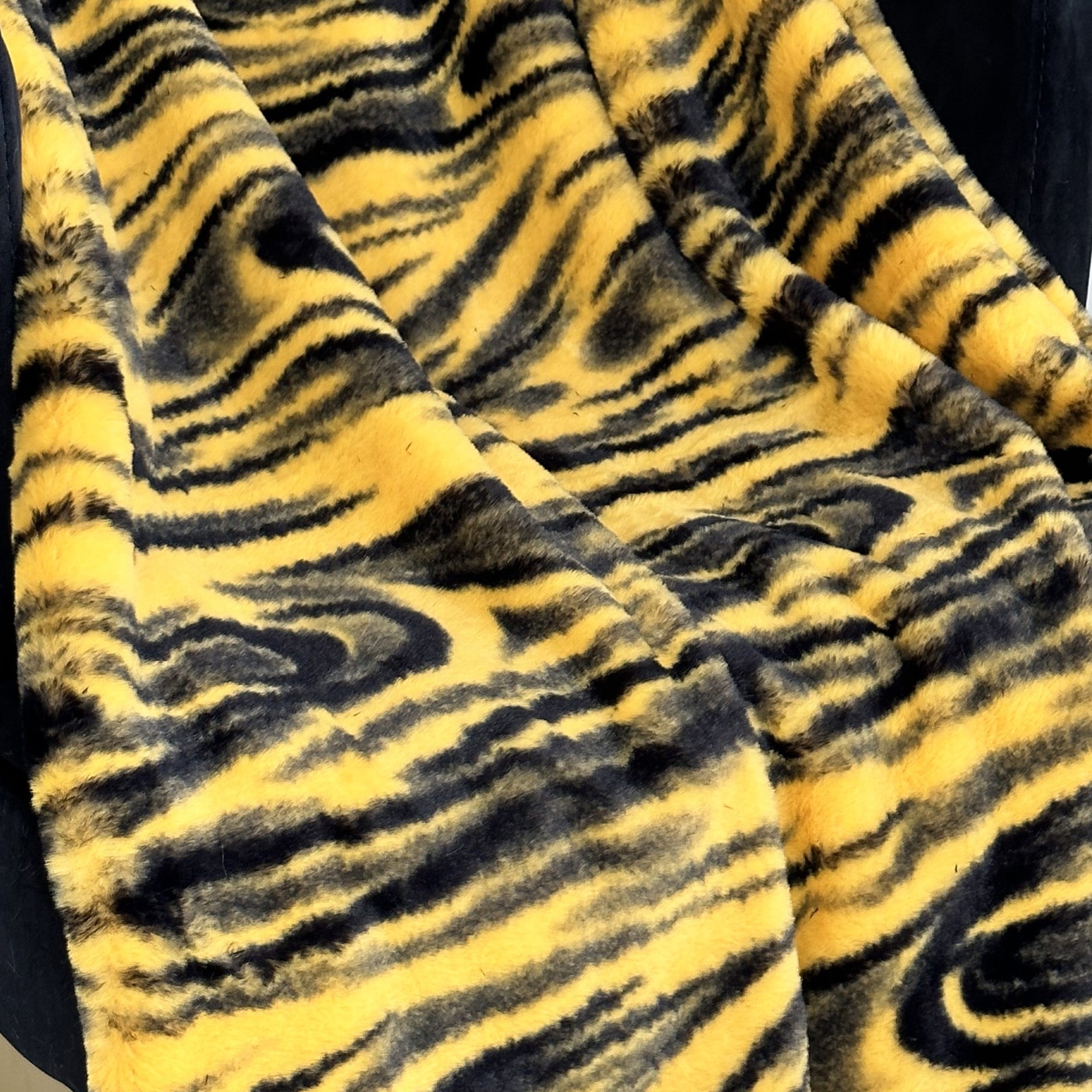Plutus Yellow Galaxy Faux Fur Luxury Throw Blanket showcasing its plush texture and vibrant yellow color, perfect for cozying up.