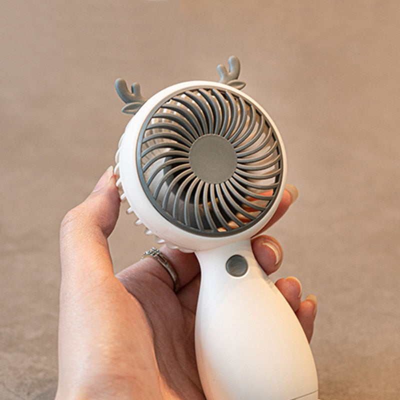 Portable Mini Fan in cartoon design, USB rechargeable, perfect for outdoor use.