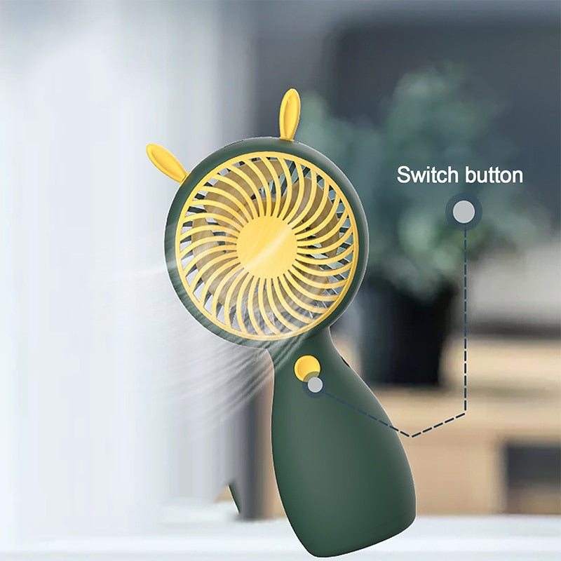 Portable Mini Fan in cartoon design, USB rechargeable, perfect for outdoor use.
