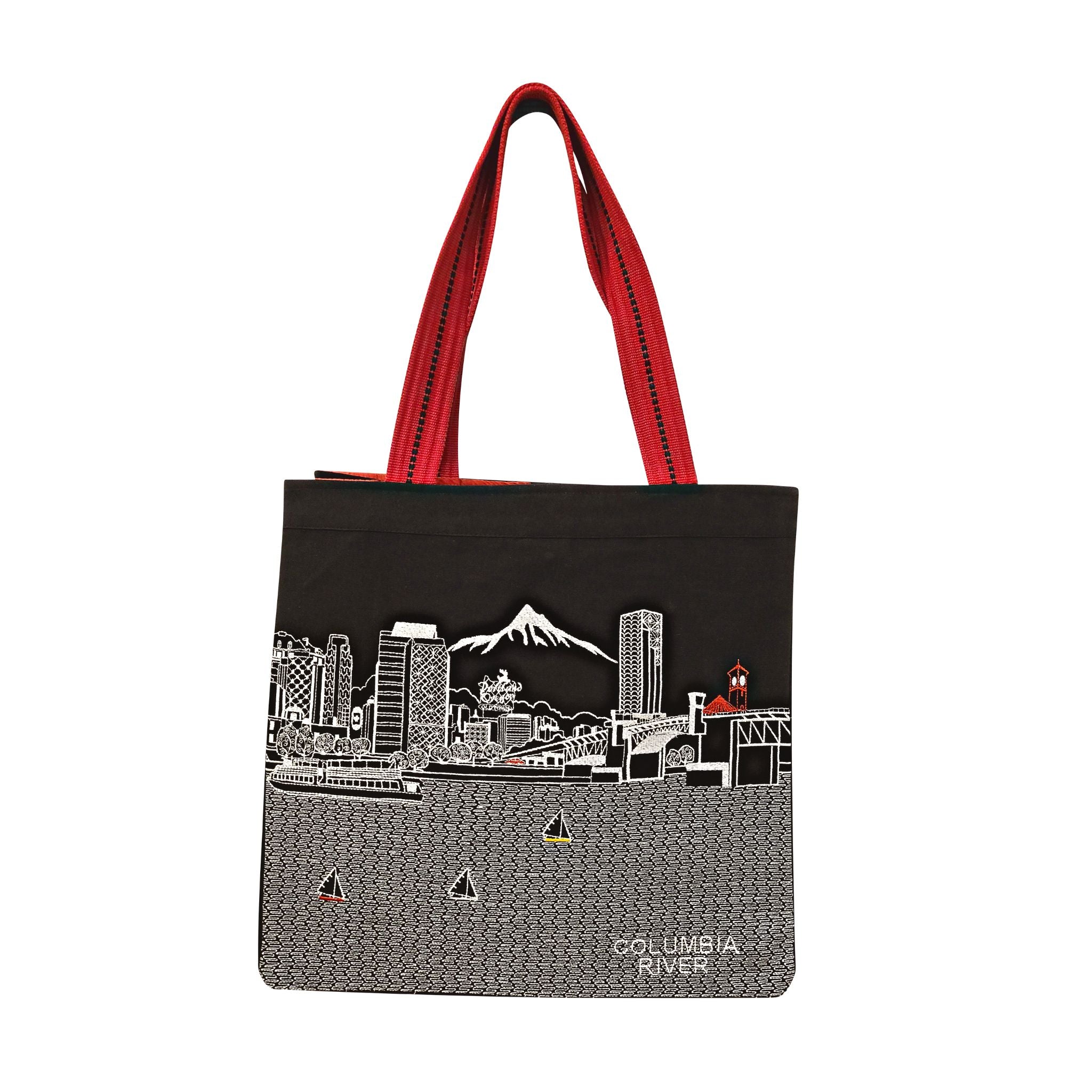 Portland Tote Bag featuring embroidered skyline design on cream and black cotton canvas with red straps.