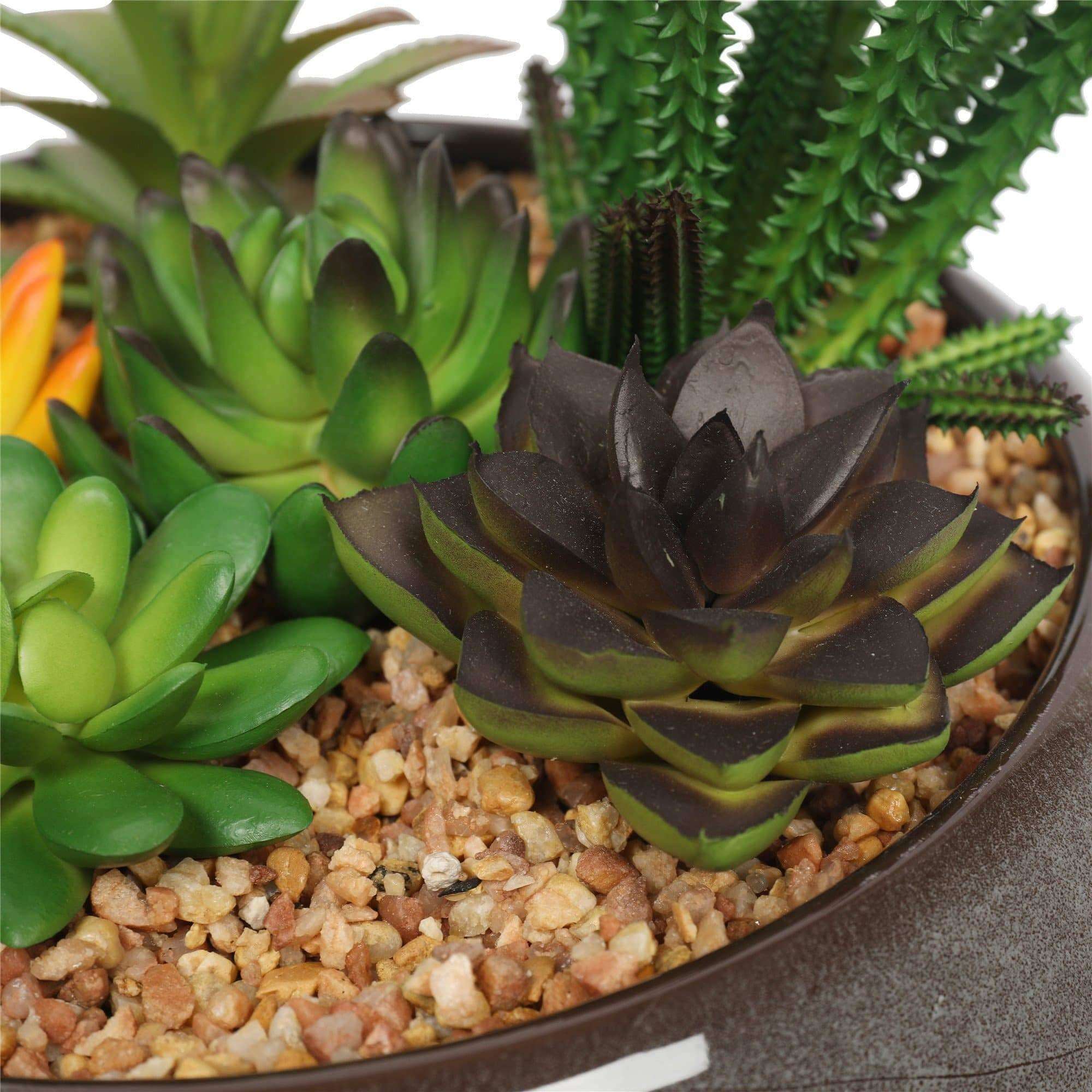 A beautifully arranged potted artificial succulent in a modern round decorative bowl, featuring realistic green succulents and decorative pebbles.