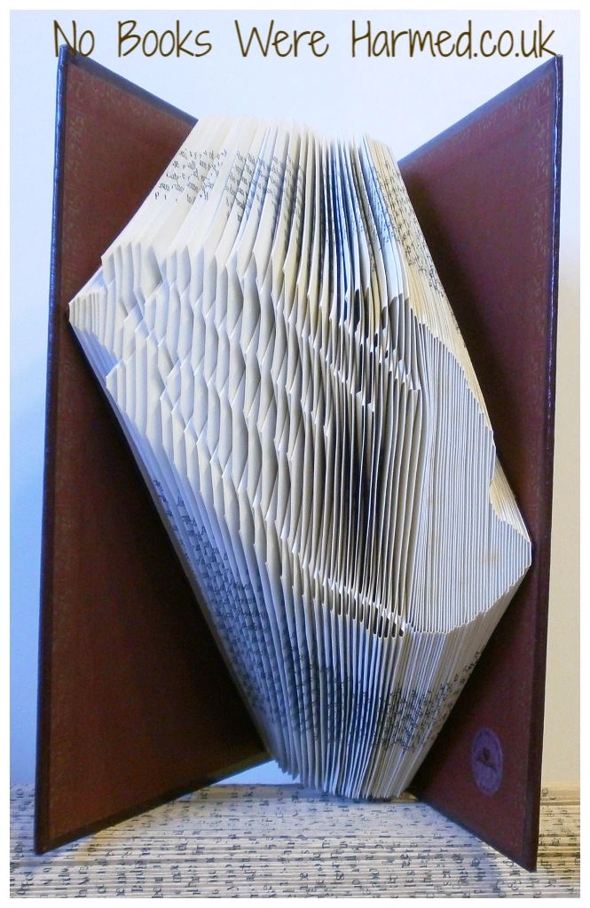 Handcrafted Praying Hands art made from vintage book pages, showcasing intricate folds and unique textures.