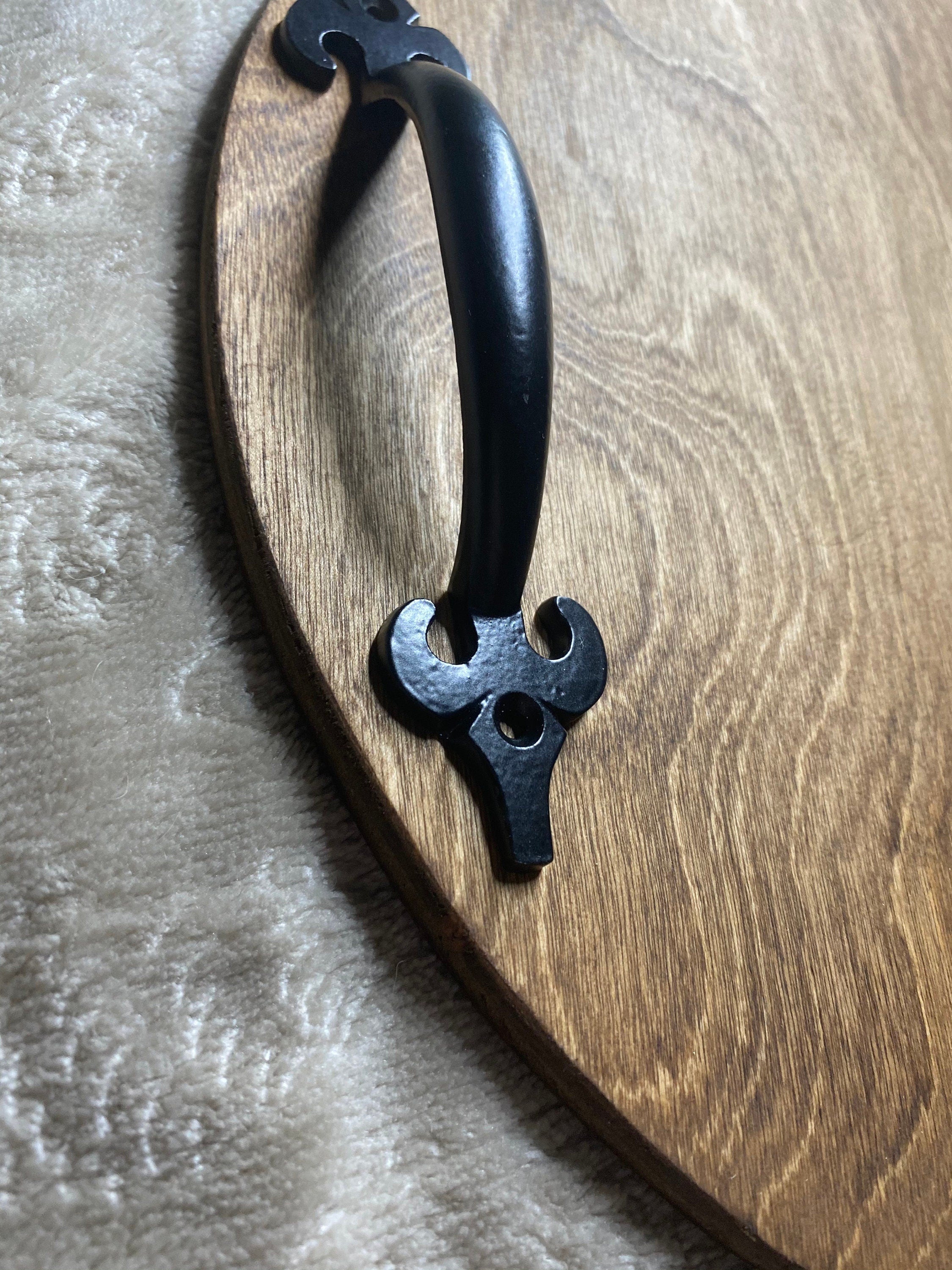 Handmade wooden serving tray with black metal handles, featuring a unique burned design and rich chestnut stain, perfect for fall decor.