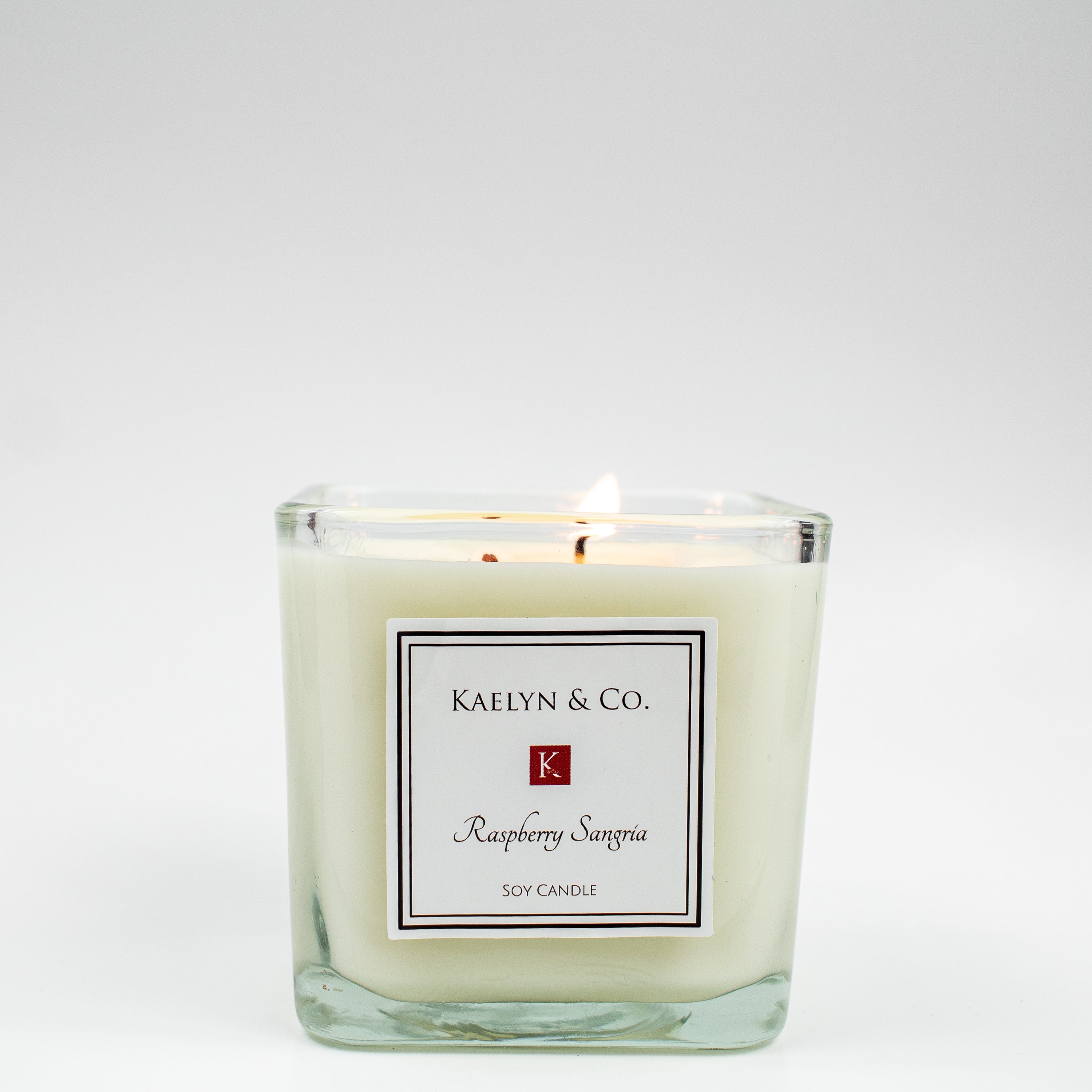 Raspberry Sangria Medium Cube Candle featuring a vibrant design with juicy raspberry and cherry notes, elegantly hand poured in a cube shape.