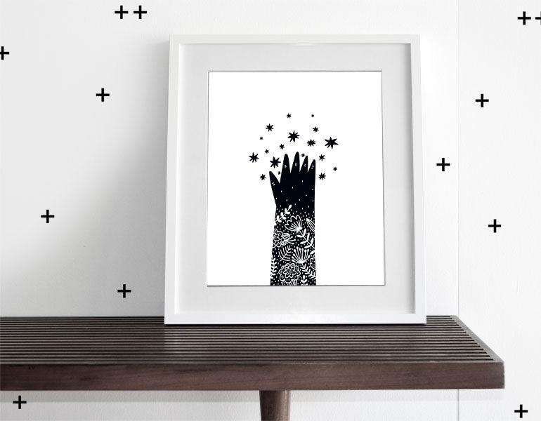 Reach for the Stars Wall Art featuring a whimsical design, perfect for modern nursery decor, framed with a white matte.
