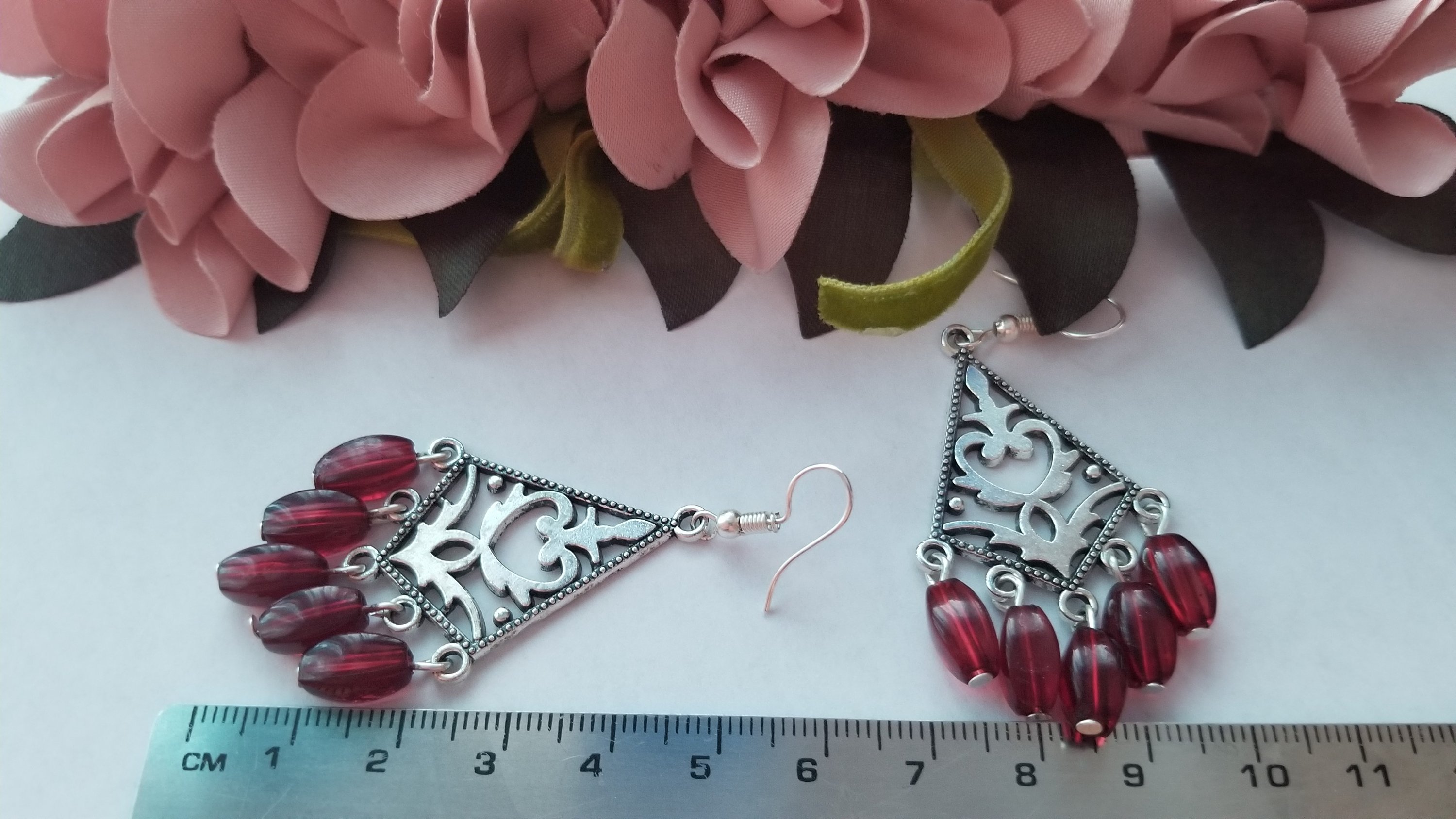 Elegant red dangling earrings with a translucent design, perfect for any occasion.