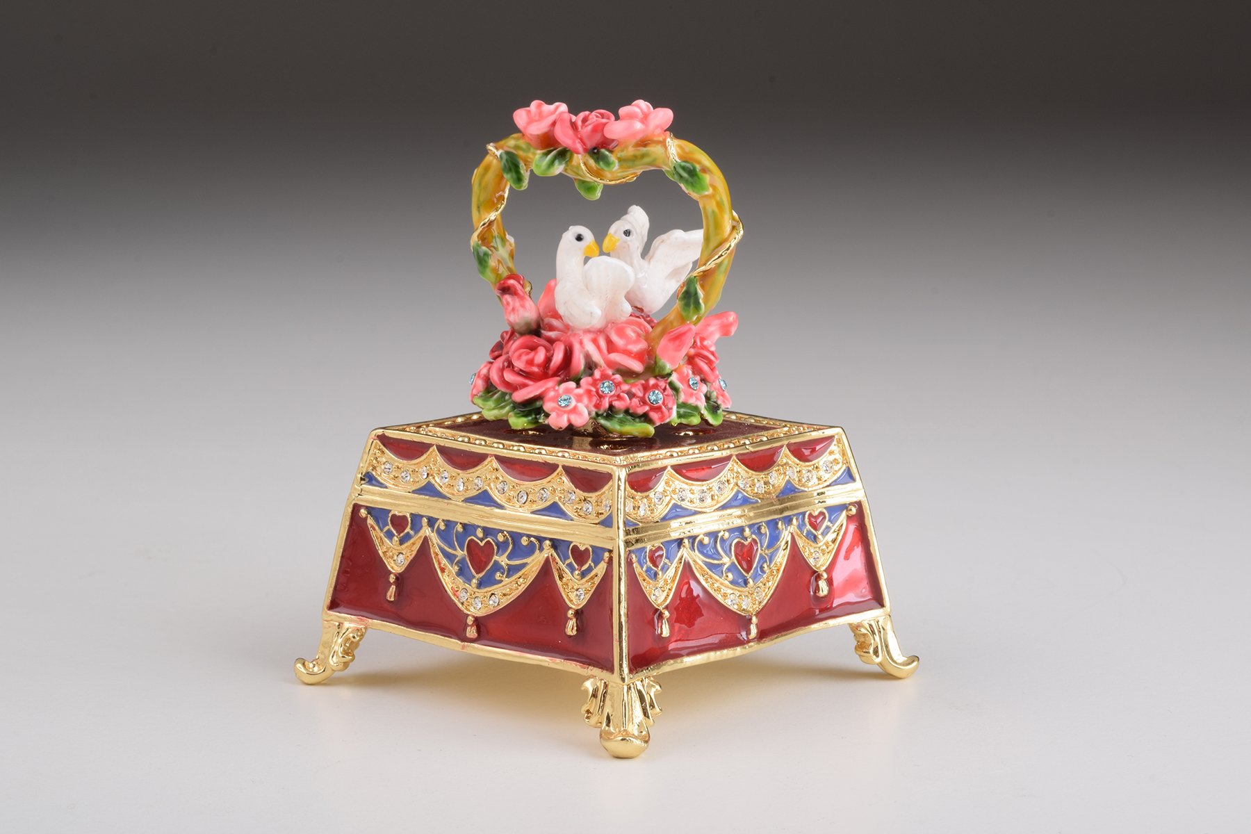 A beautifully crafted red trinket box adorned with roses and two white doves, embellished with Austrian crystals and plated with gold or silver.