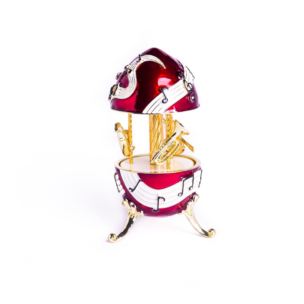 Red Musical Carousel trinket box featuring violin, saxophone, and trumpet designs, adorned with Austrian crystals and gold or silver plating.