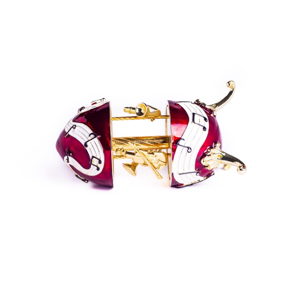 Red Musical Carousel trinket box featuring violin, saxophone, and trumpet designs, adorned with Austrian crystals and gold or silver plating.