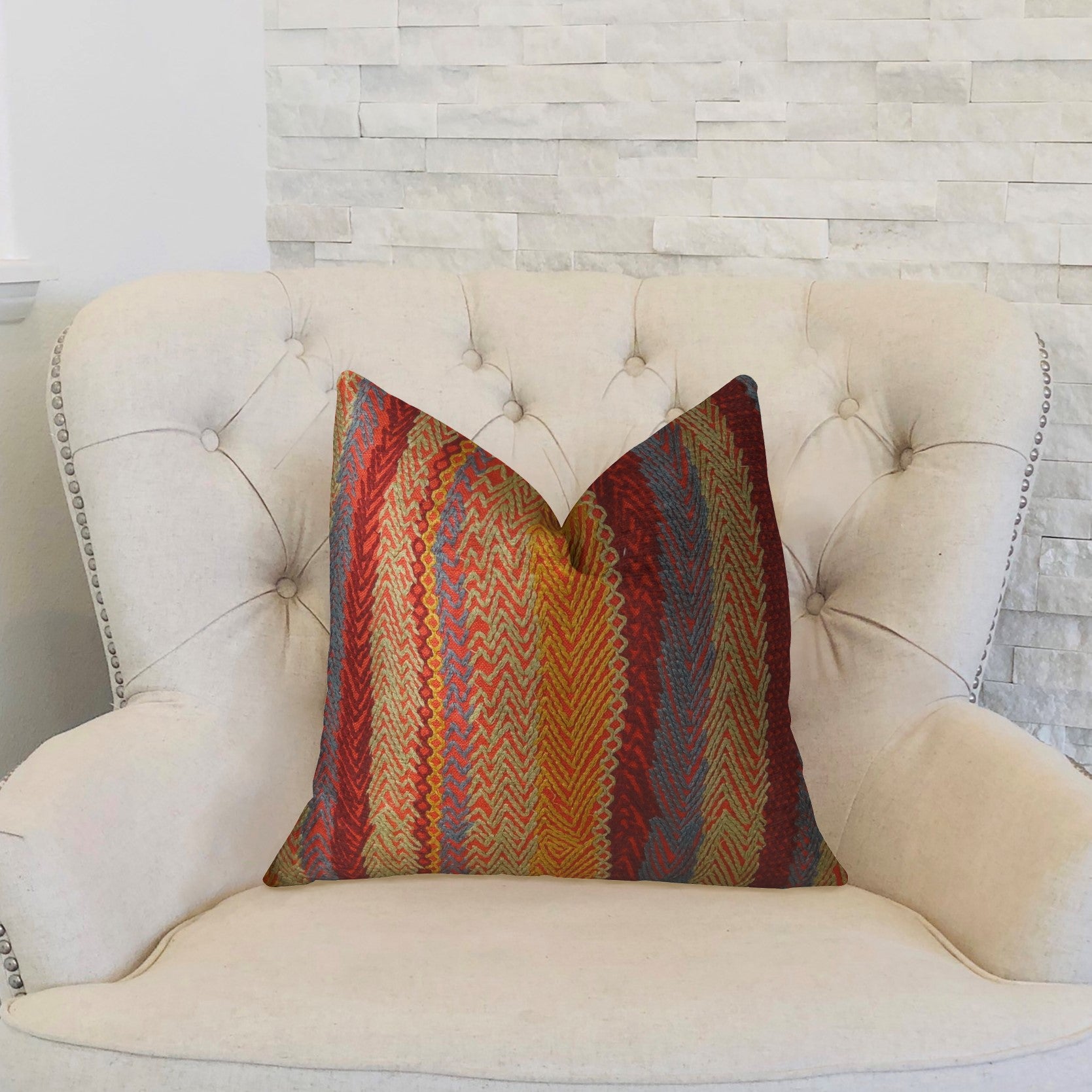 A luxurious handmade pillow featuring a vibrant striped pattern in red, blue, and orange, showcasing its elegant design and quality craftsmanship.
