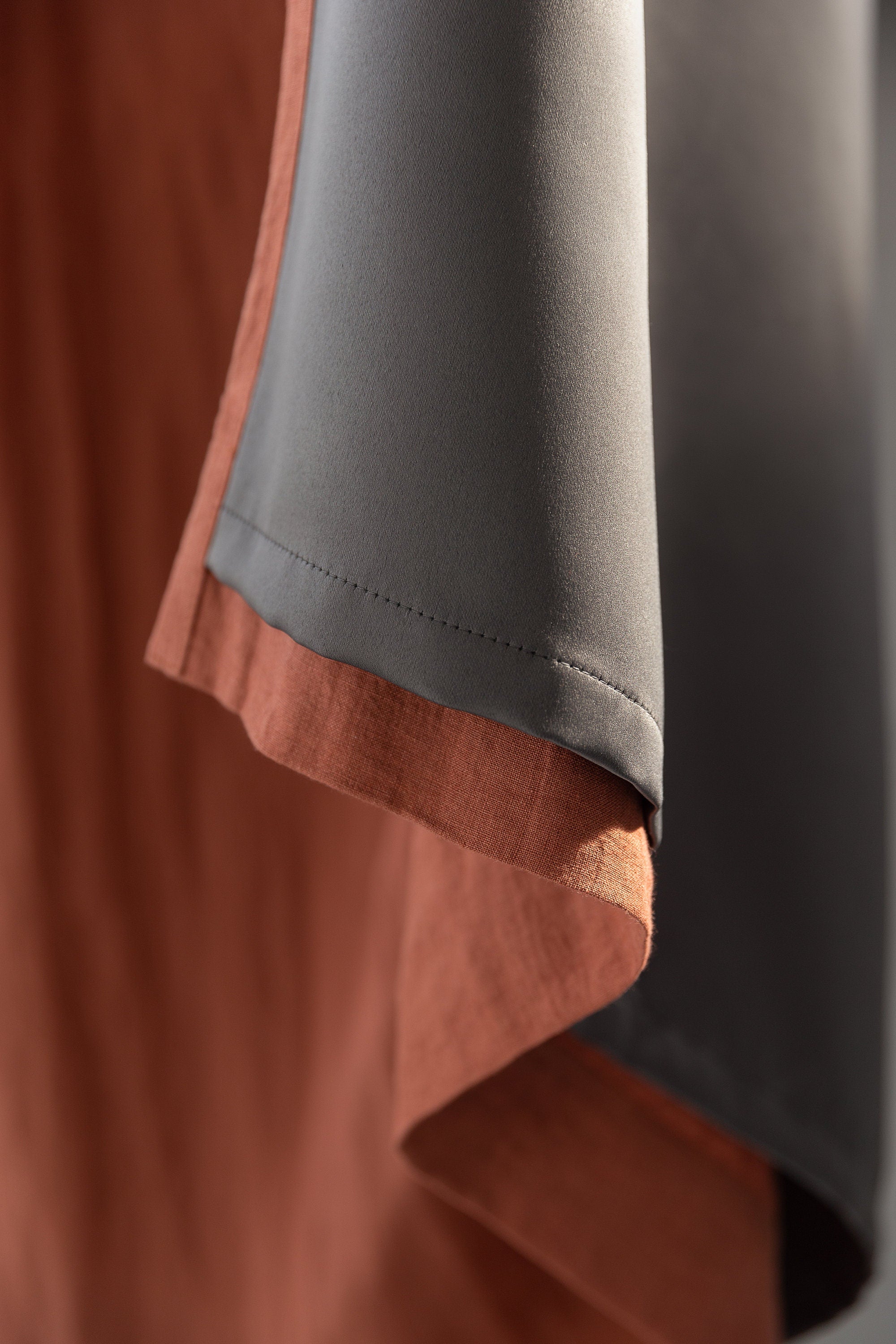 Reddish brown linen curtain with blackout feature, elegantly draped with a rod pocket for easy hanging.