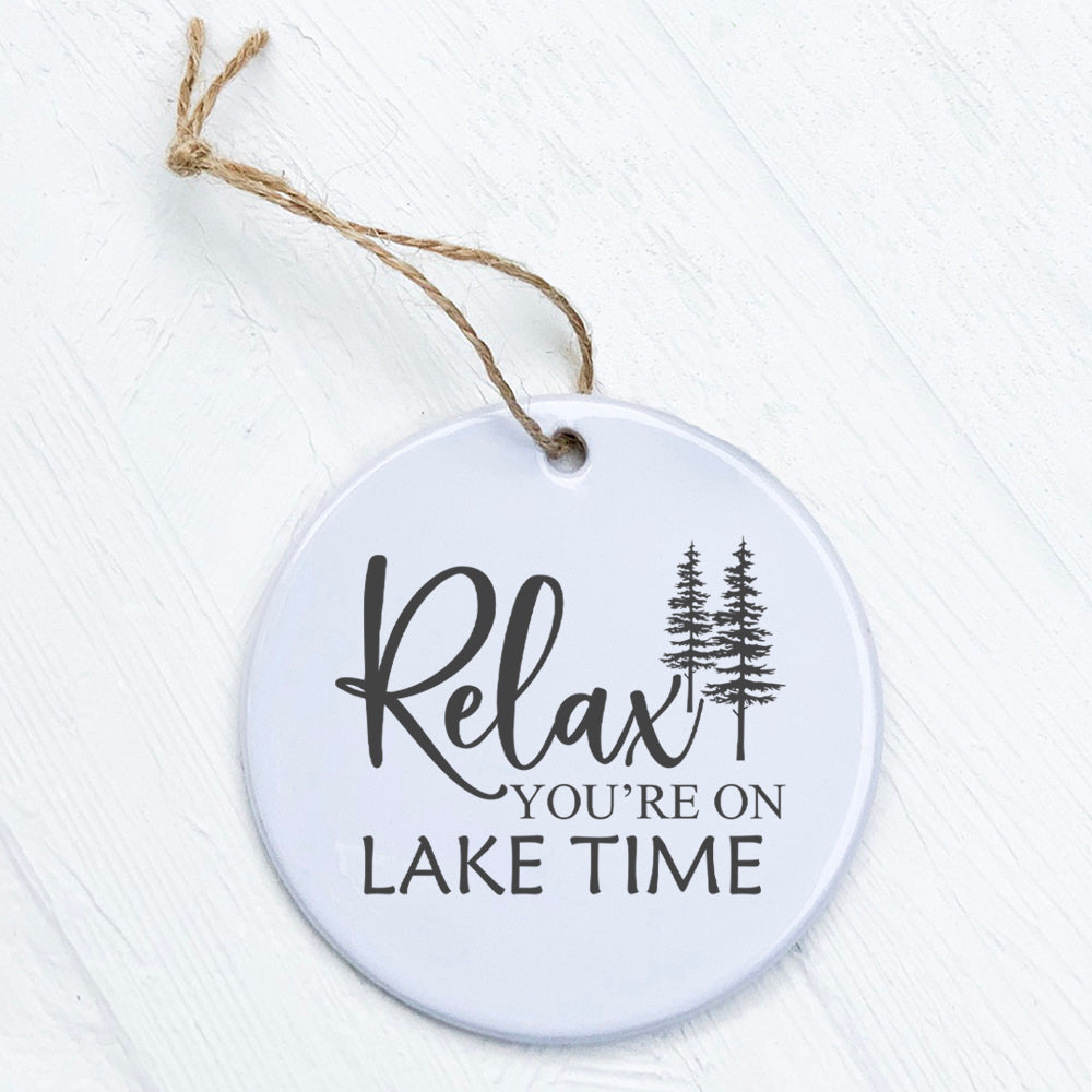 Relax You're on Lake Time porcelain ornament featuring trees, 2.75 inches in diameter, with a smooth gloss finish.