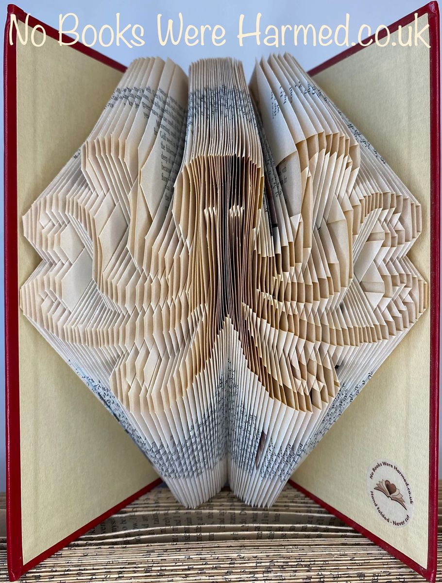 Handcrafted octopus art made from vintage book pages, showcasing intricate folds and unique design.