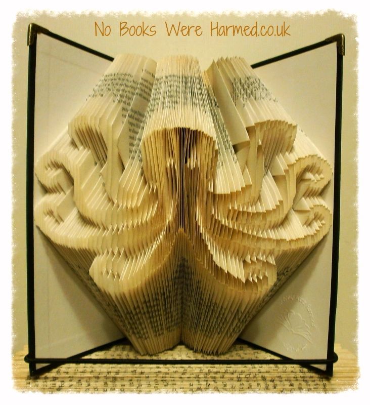 Handcrafted octopus art made from vintage book pages, showcasing intricate folds and unique design.