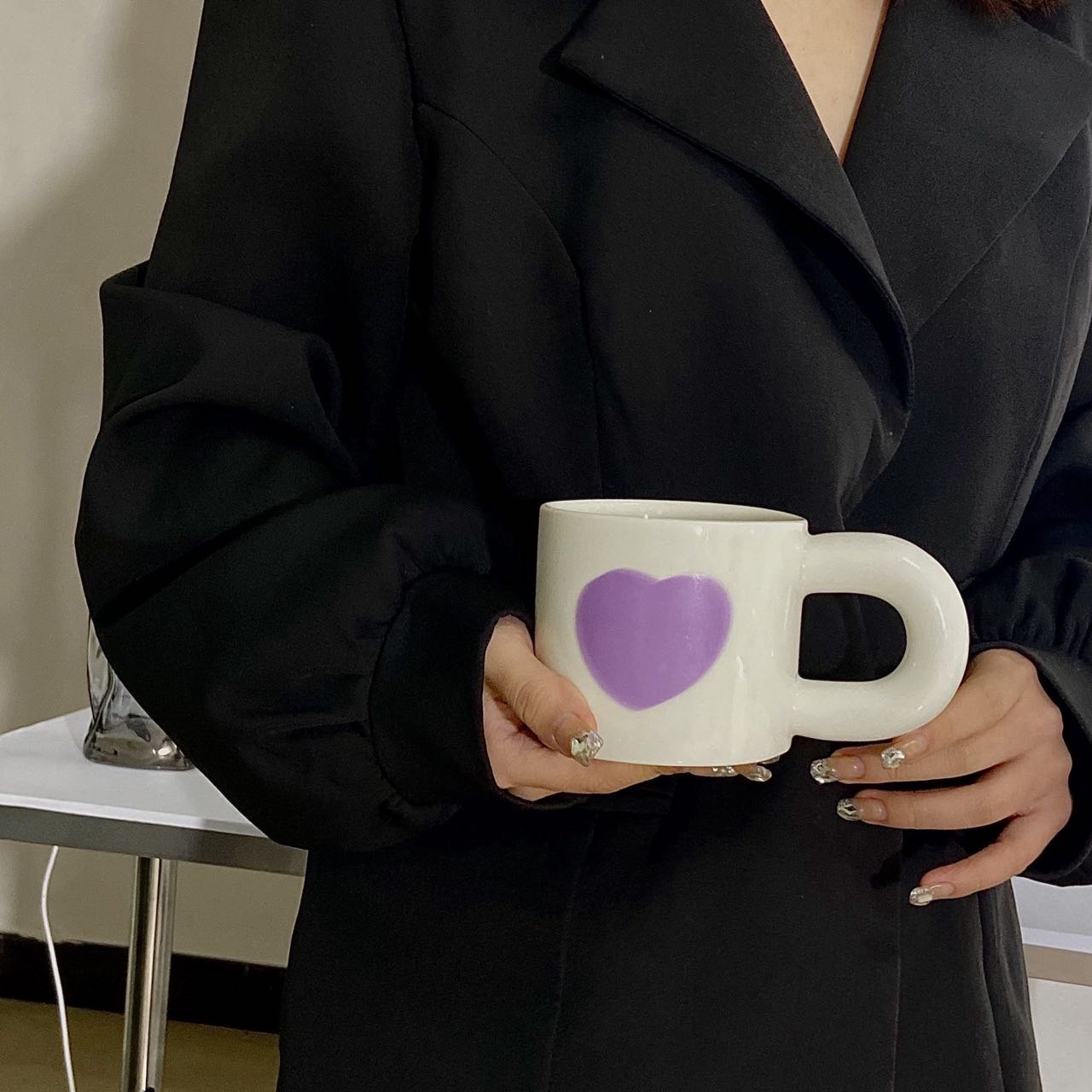 A set of colorful retro ceramic coffee mugs featuring heart prints, showcasing their unique vintage style and handcrafted quality.