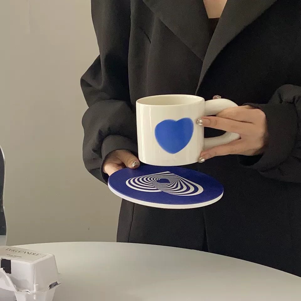 A set of colorful retro ceramic coffee mugs featuring heart prints, showcasing their unique vintage style and handcrafted quality.