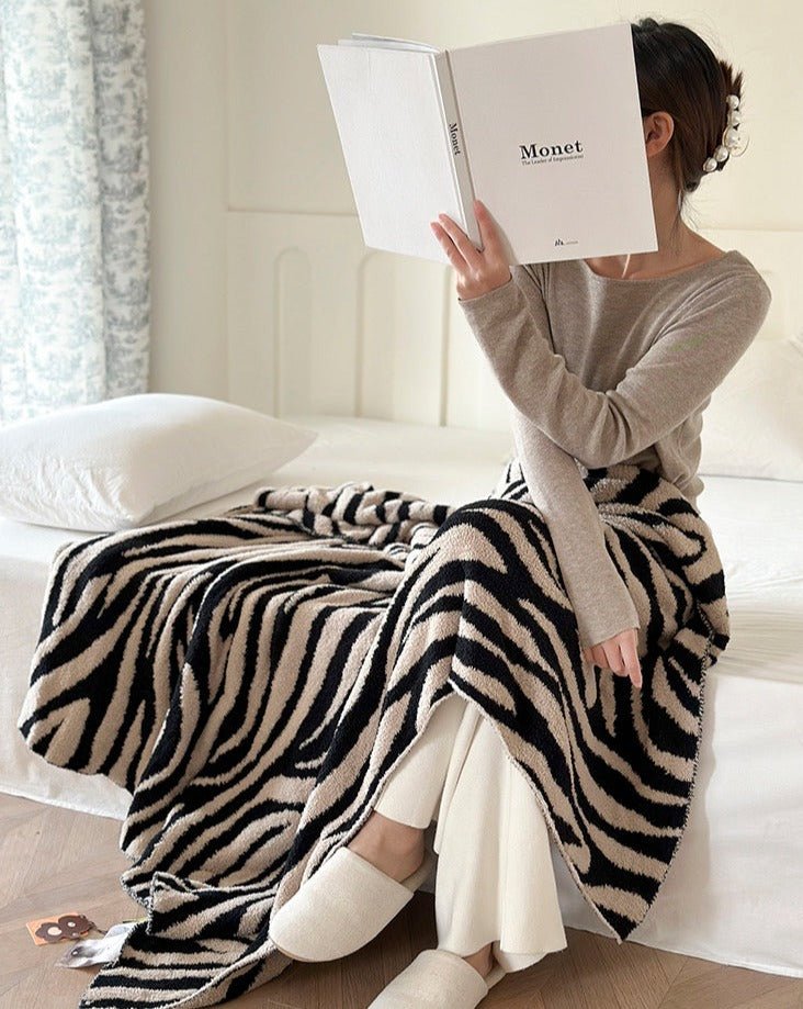 A cozy Retro Style Zebra Print Microfiber Throw Blanket featuring a stylish zebra pattern, perfect for home decor and comfort.