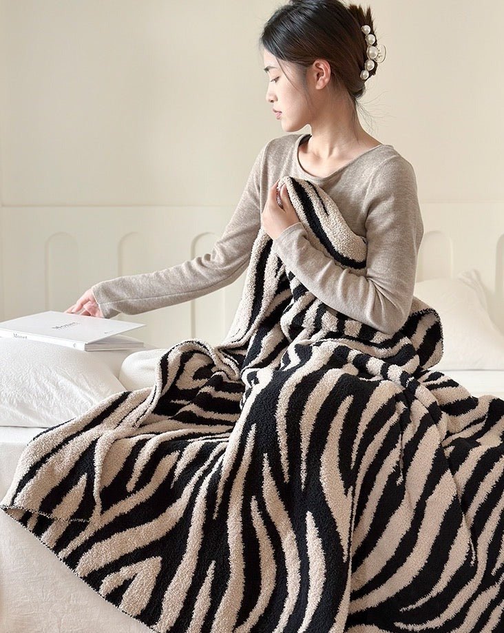 A cozy Retro Style Zebra Print Microfiber Throw Blanket featuring a stylish zebra pattern, perfect for home decor and comfort.