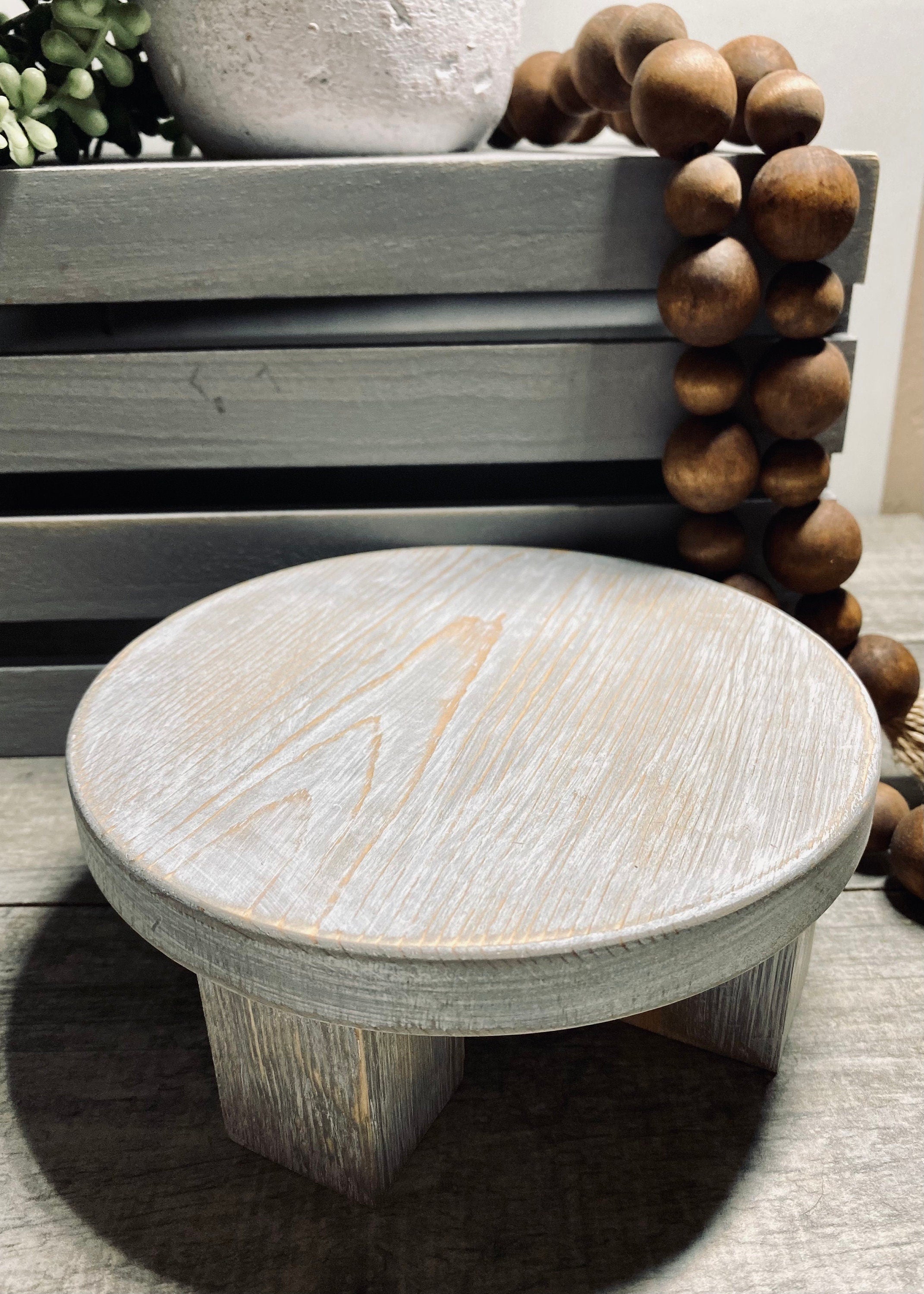 Round wooden riser in Classic Gray with a whitewashed finish, showcasing its rustic charm and sturdy design, perfect for displaying decor items.