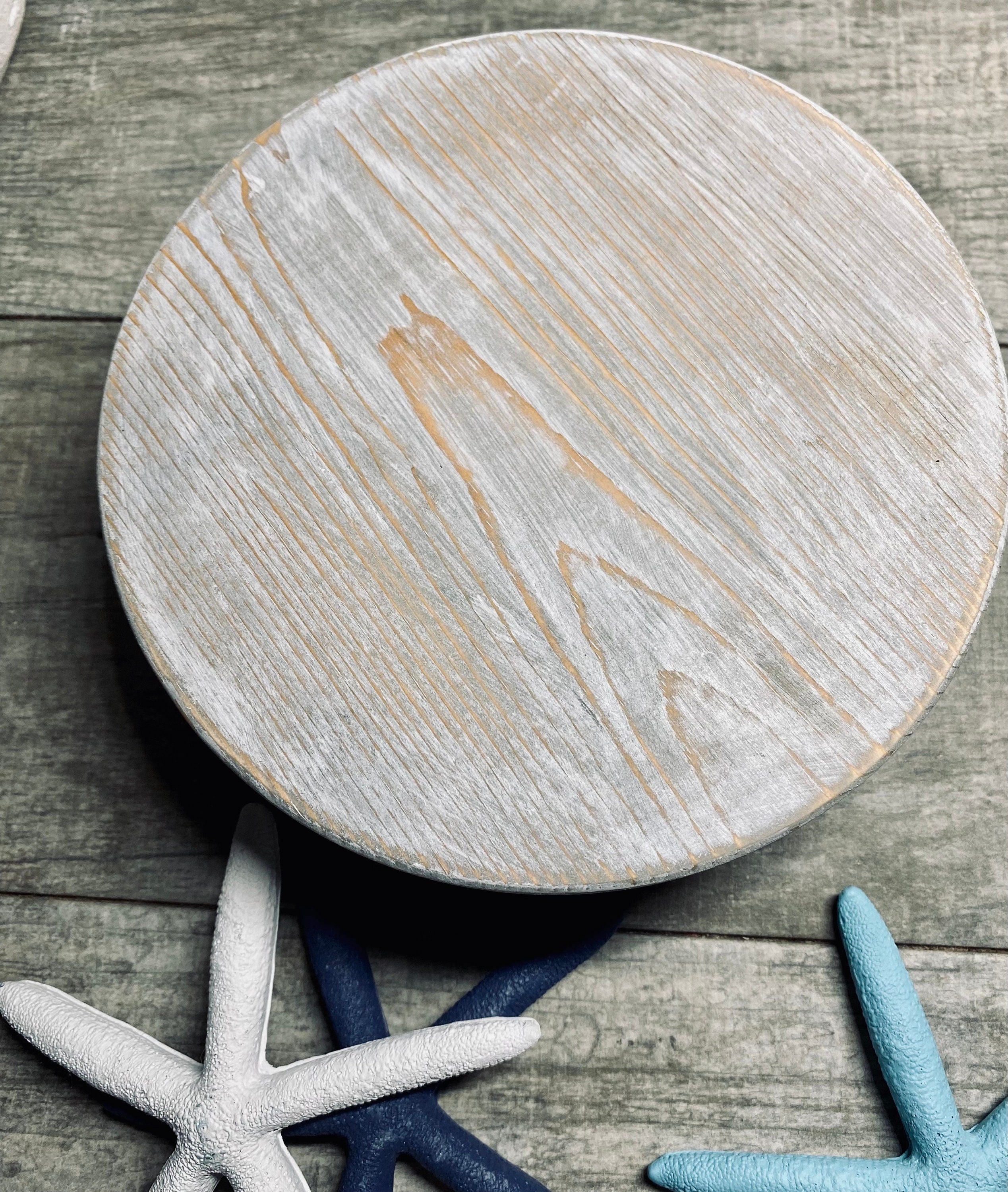 Round wooden riser in Classic Gray with a whitewashed finish, showcasing its rustic charm and sturdy design, perfect for displaying decor items.