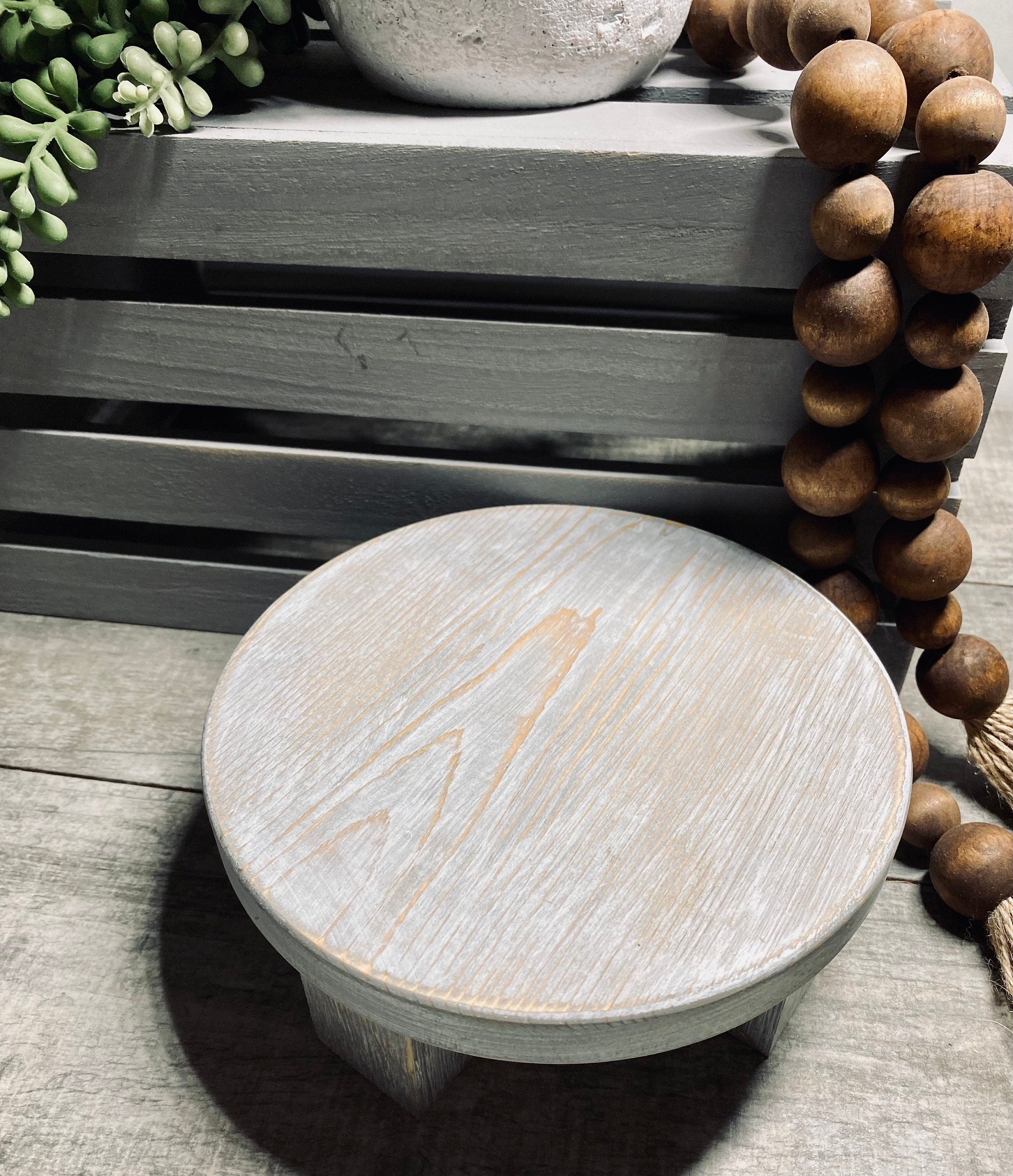 Round wooden riser in Classic Gray with a whitewashed finish, showcasing its rustic charm and sturdy design, perfect for displaying decor items.