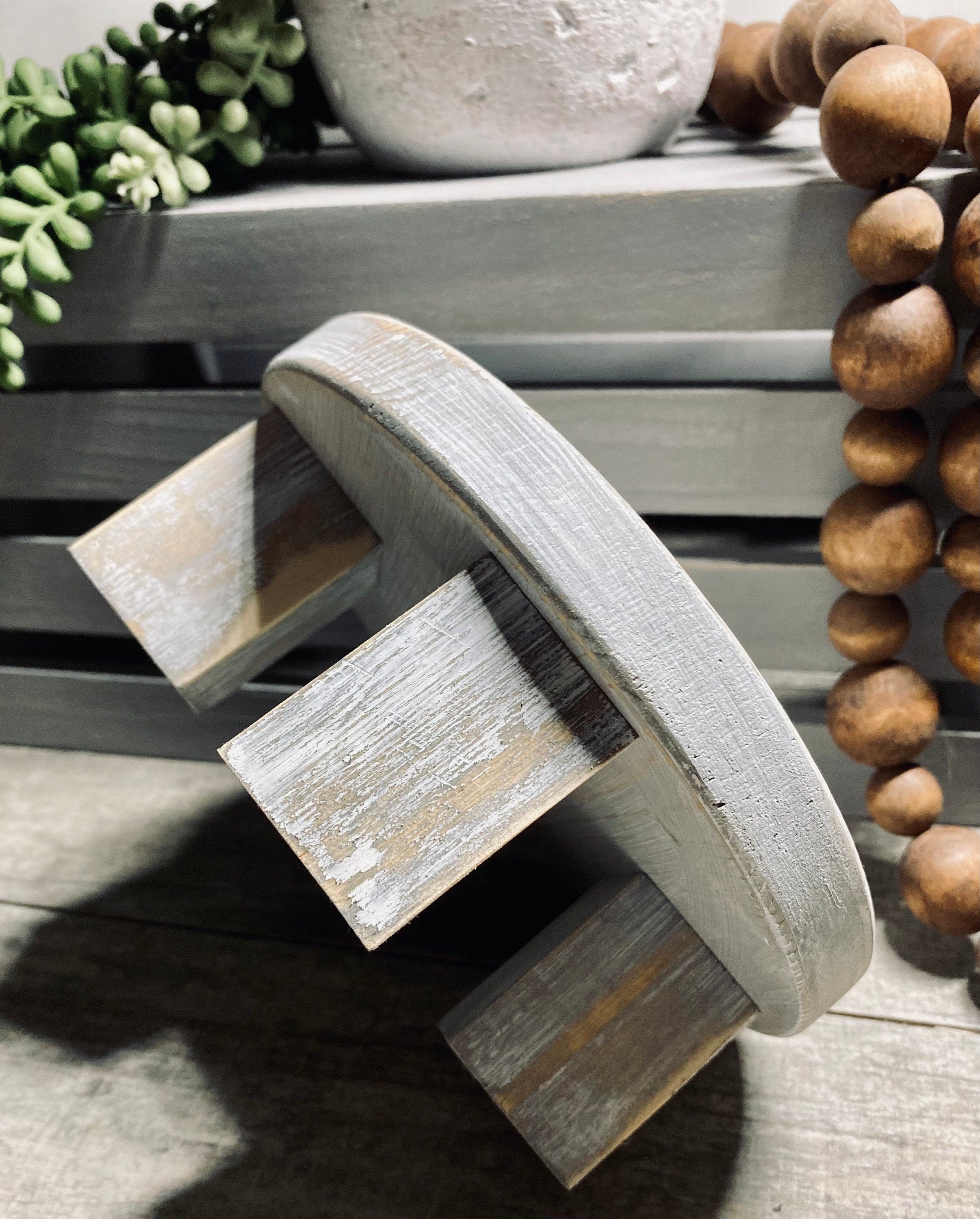 Round wooden riser in Classic Gray with a whitewashed finish, showcasing its rustic charm and sturdy design, perfect for displaying decor items.