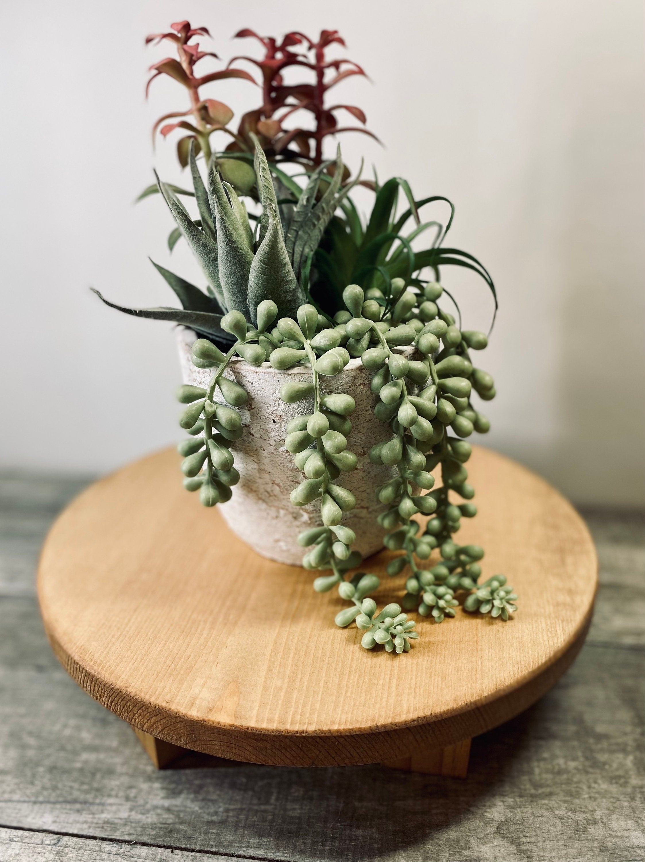 A round wooden riser made of solid pine, stained in Special Walnut, showcasing its unique grain and sturdy base, ideal for displaying soaps, candles, or plants.