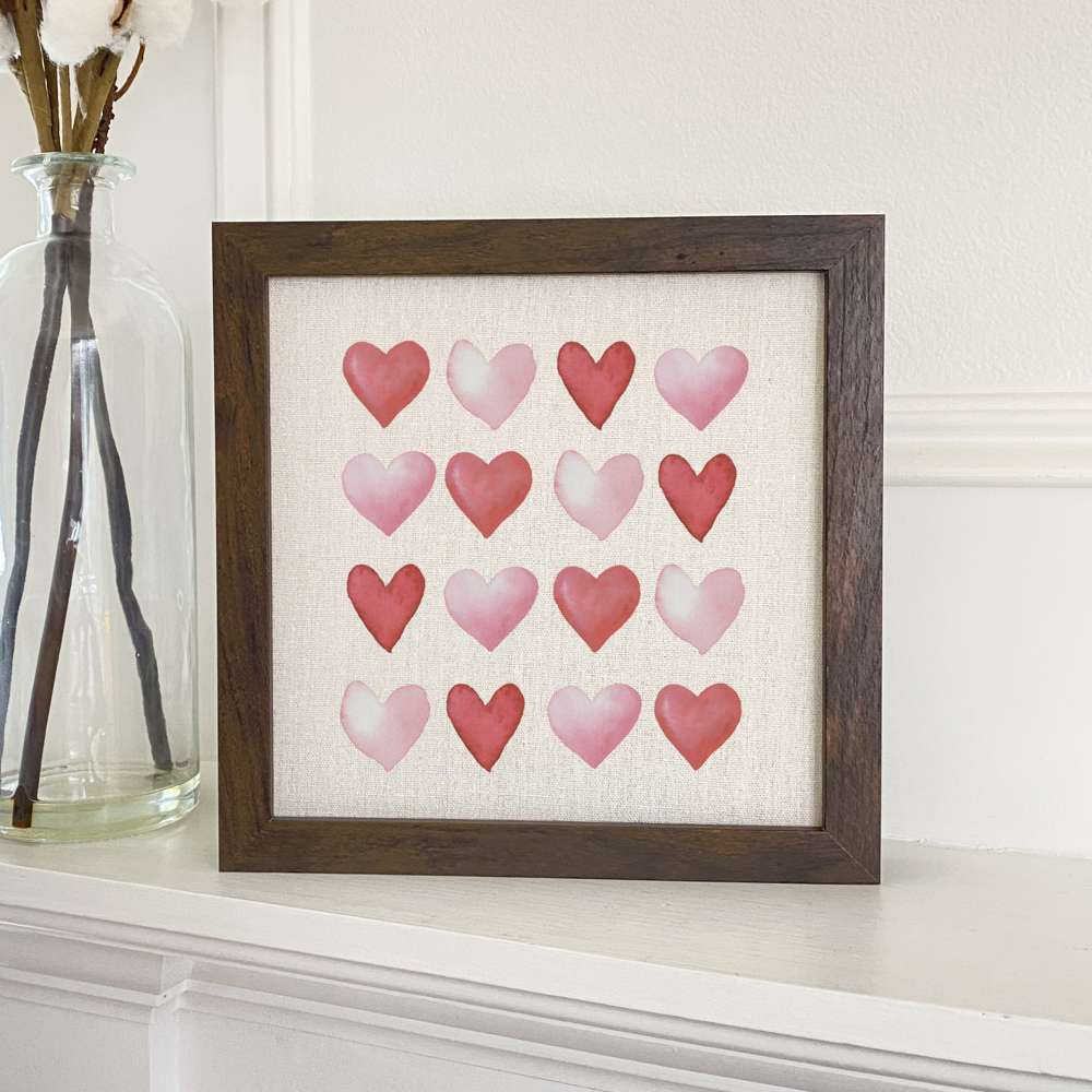 Rows of Hearts Framed Sign with a natural wood frame and linen-look background, showcasing a heart design.