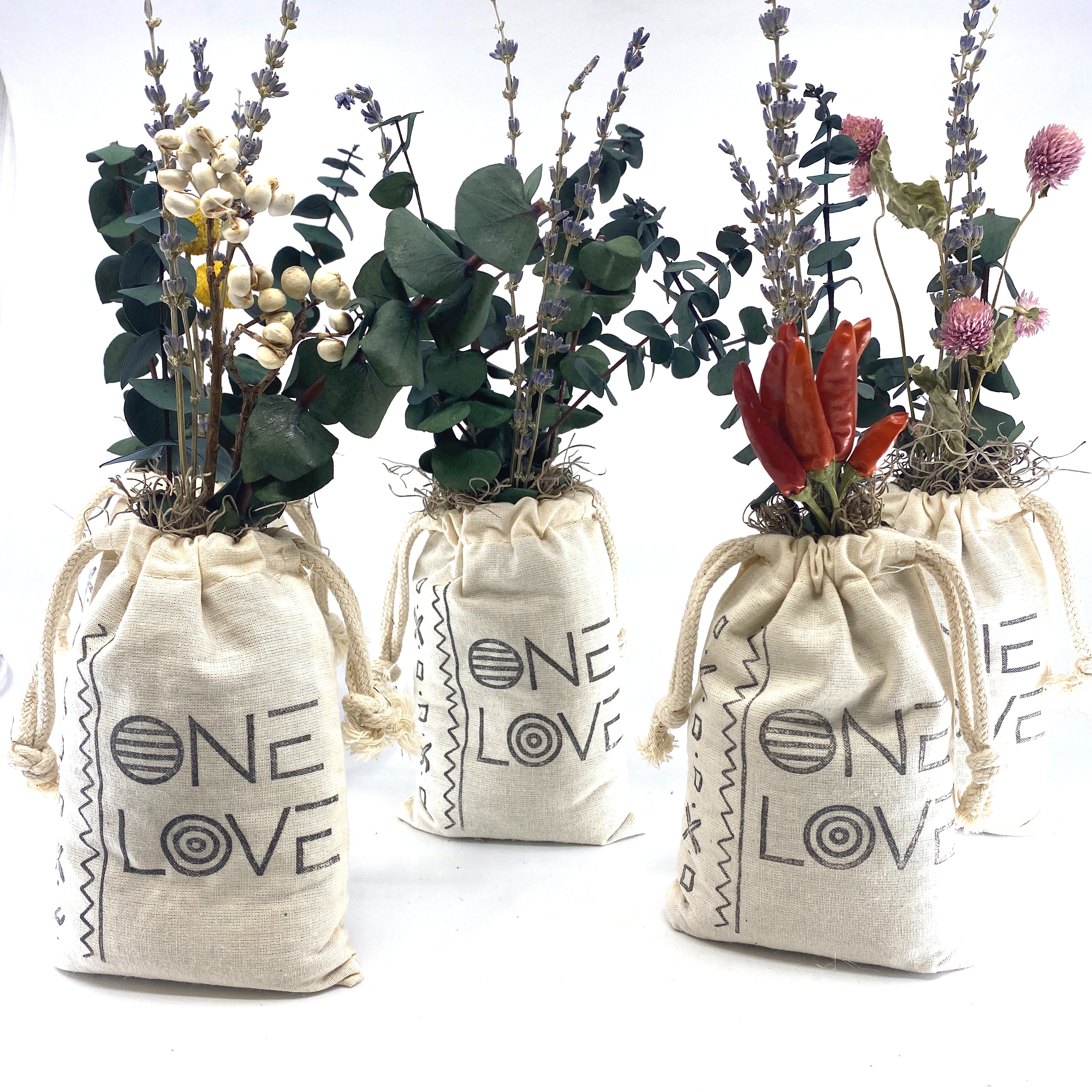 A beautifully arranged organic dried flower bouquet in a stylish sack, featuring lavender, eucalyptus, and accent flowers, topped with Spanish moss.