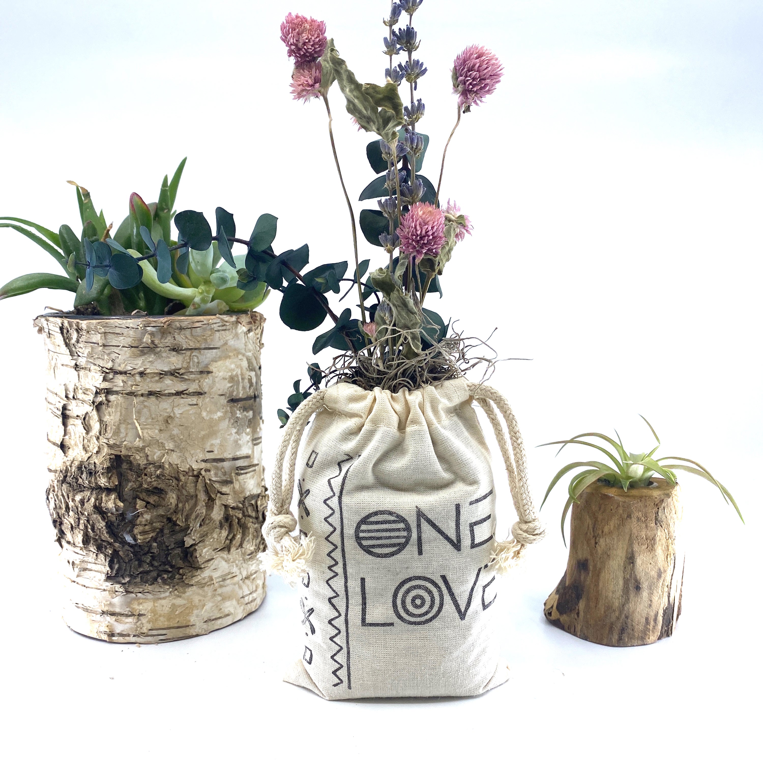 A beautifully arranged organic dried flower bouquet in a stylish sack, featuring lavender, eucalyptus, and accent flowers, topped with Spanish moss.