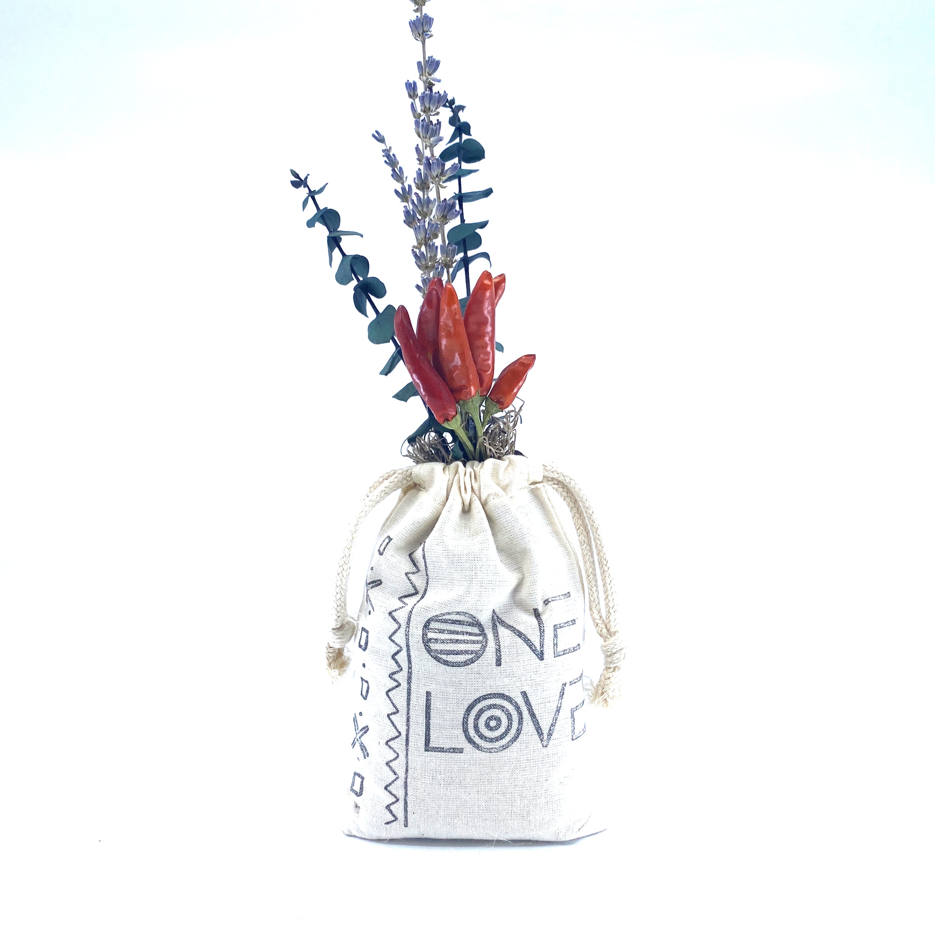 A beautifully arranged organic dried flower bouquet in a stylish sack, featuring lavender, eucalyptus, and accent flowers, topped with Spanish moss.