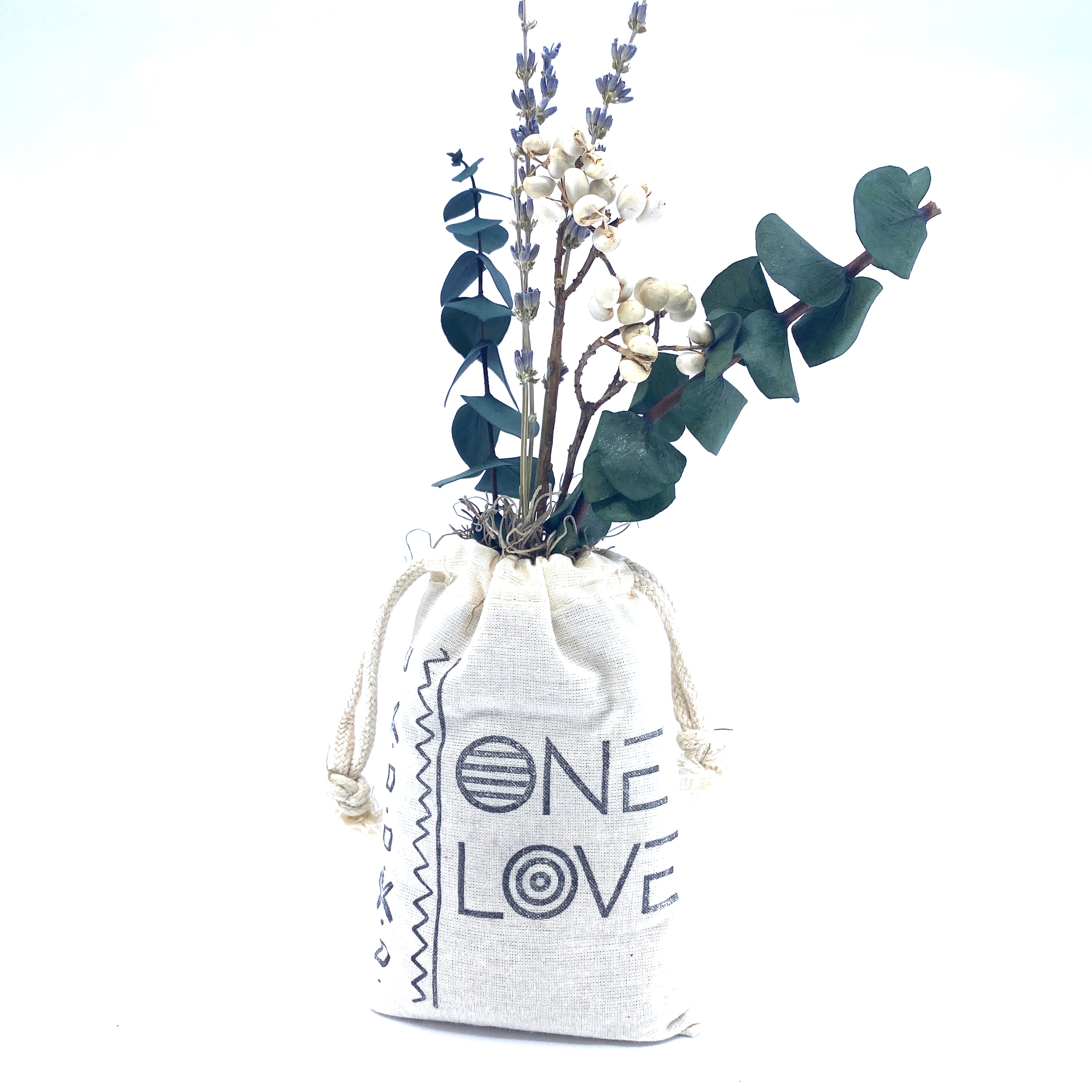 A beautifully arranged organic dried flower bouquet in a stylish sack, featuring lavender, eucalyptus, and accent flowers, topped with Spanish moss.