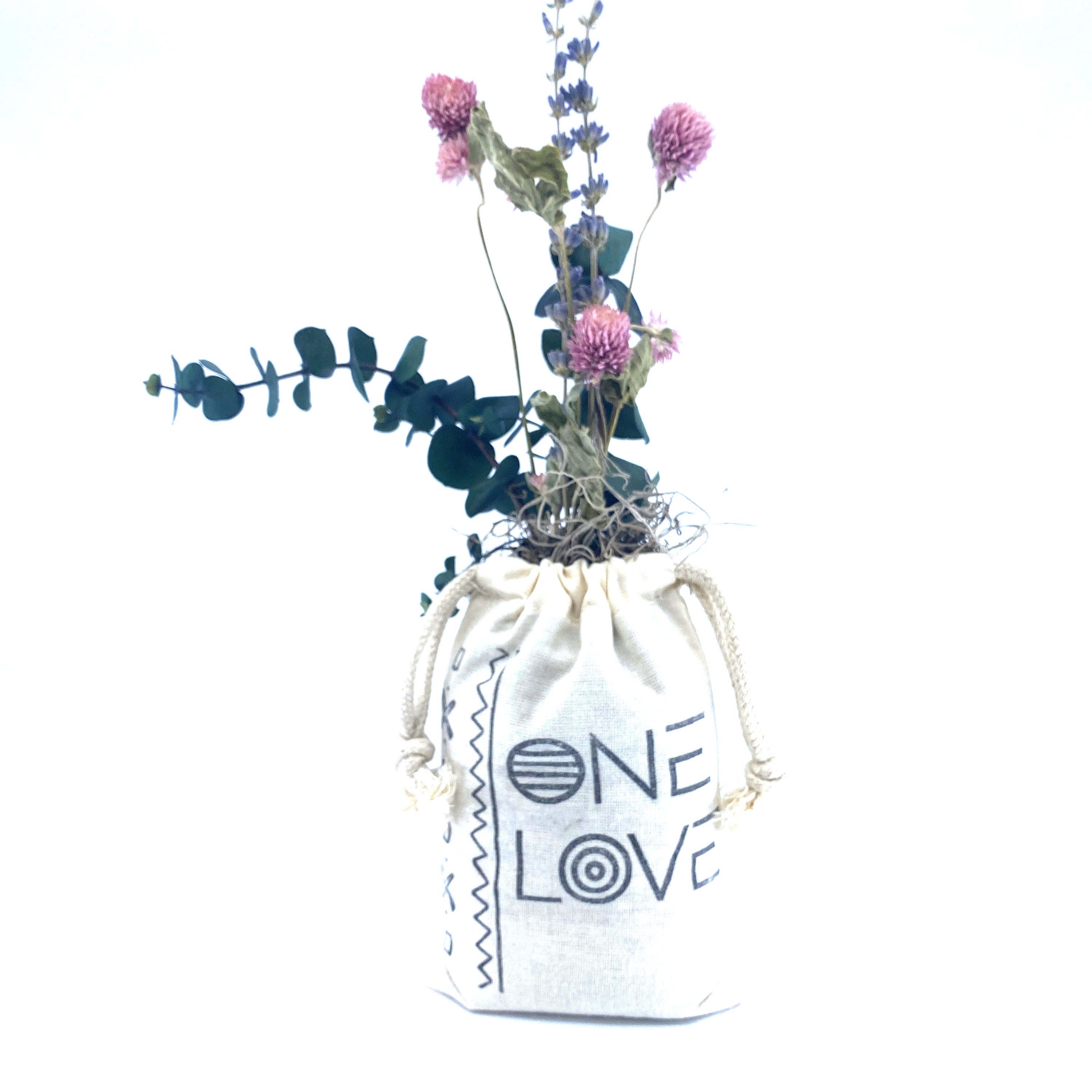 A beautifully arranged organic dried flower bouquet in a stylish sack, featuring lavender, eucalyptus, and accent flowers, topped with Spanish moss.