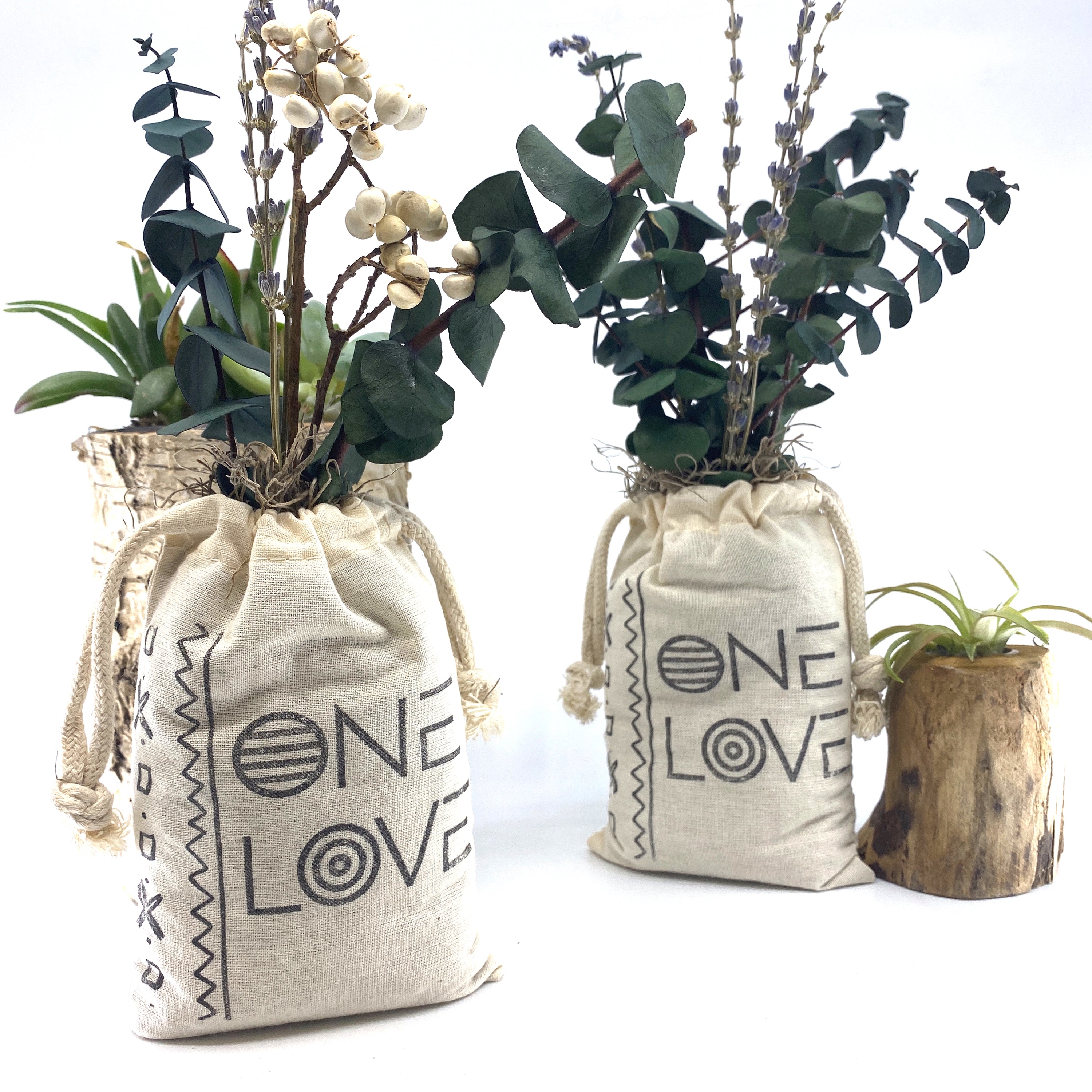 A beautifully arranged organic dried flower bouquet in a stylish sack, featuring lavender, eucalyptus, and accent flowers, topped with Spanish moss.