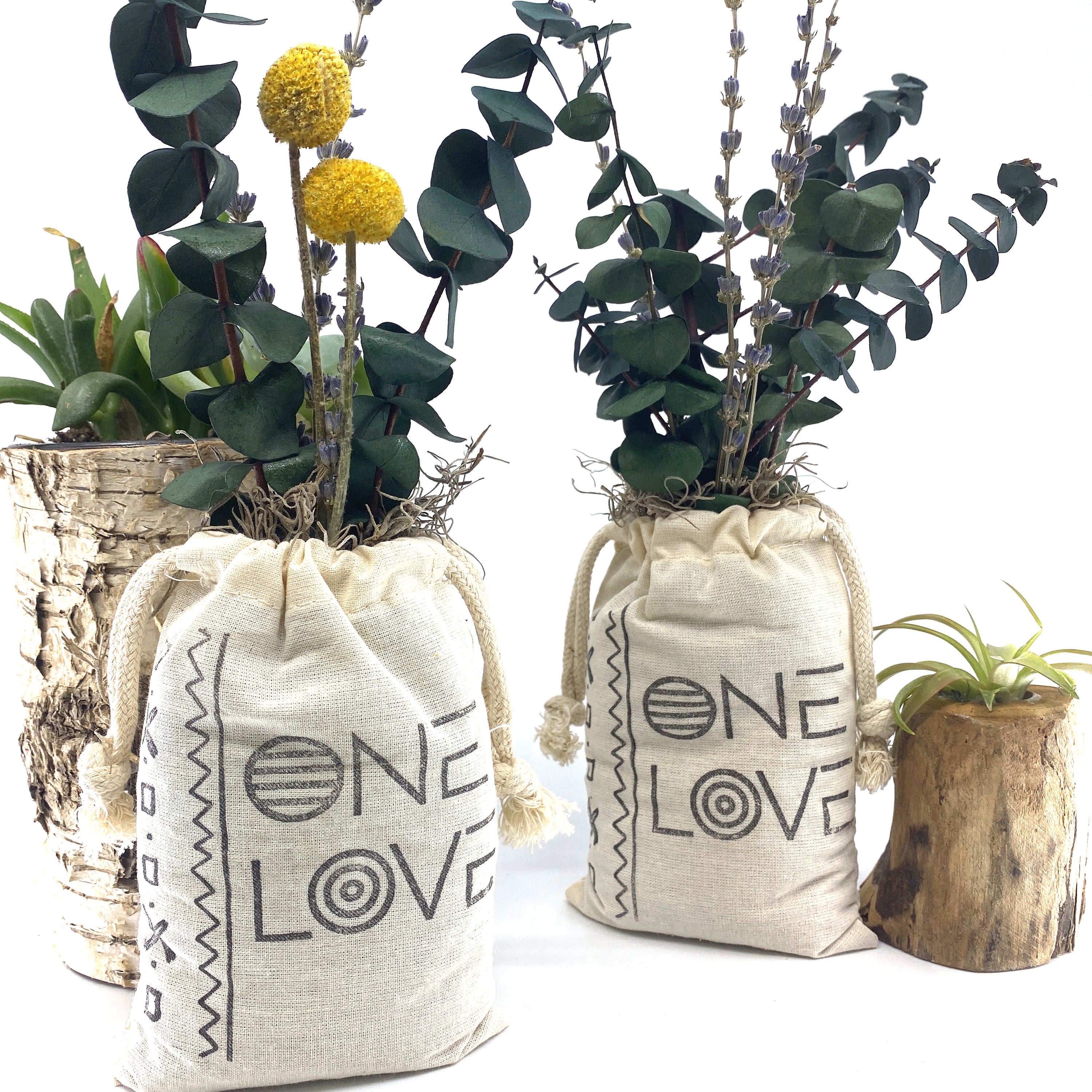 A beautifully arranged organic dried flower bouquet in a stylish sack, featuring lavender, eucalyptus, and accent flowers, topped with Spanish moss.