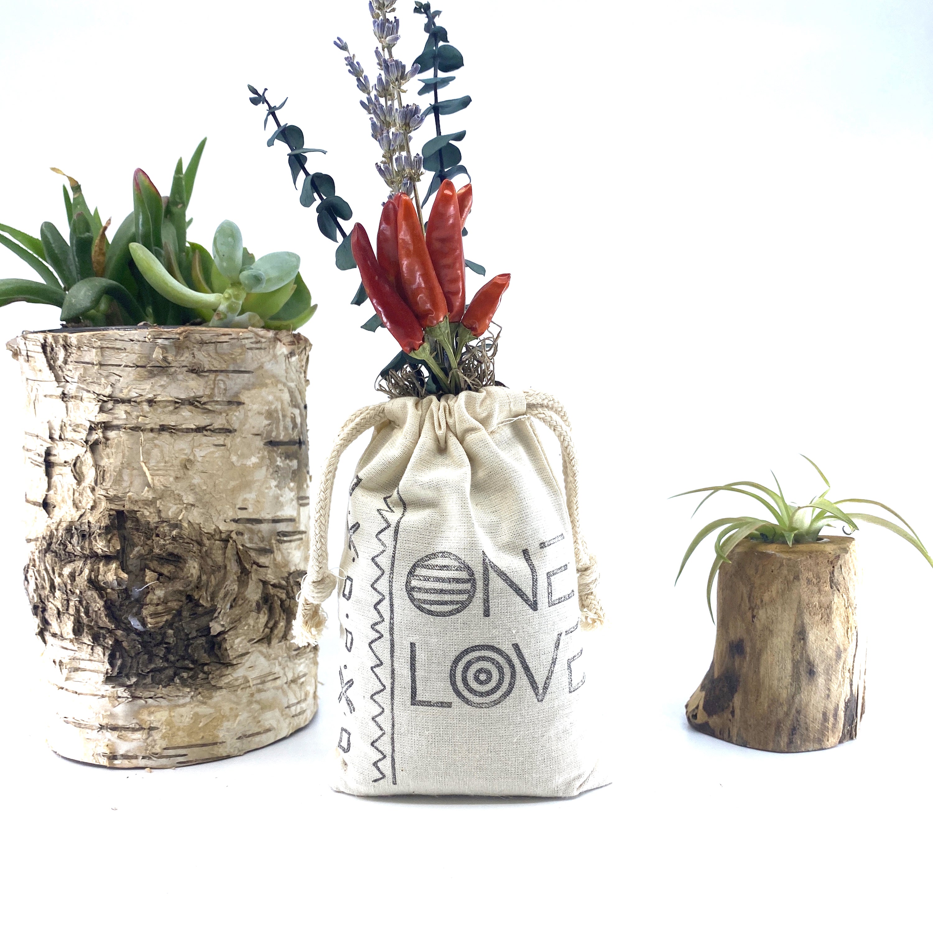 A beautifully arranged organic dried flower bouquet in a stylish sack, featuring lavender, eucalyptus, and accent flowers, topped with Spanish moss.