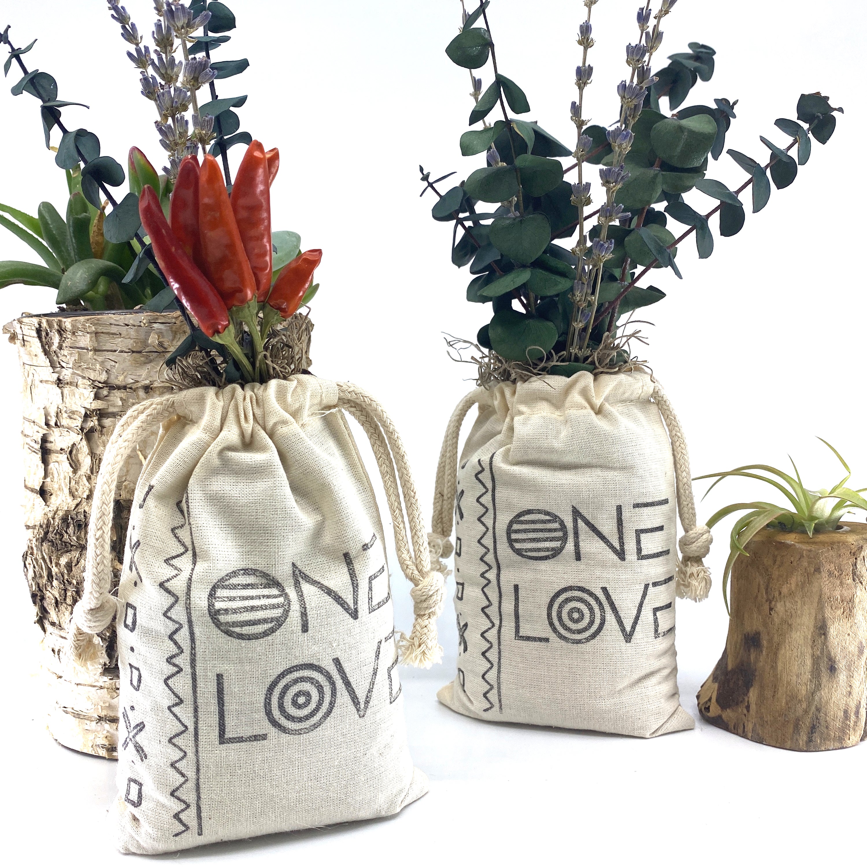 A beautifully arranged organic dried flower bouquet in a stylish sack, featuring lavender, eucalyptus, and accent flowers, topped with Spanish moss.