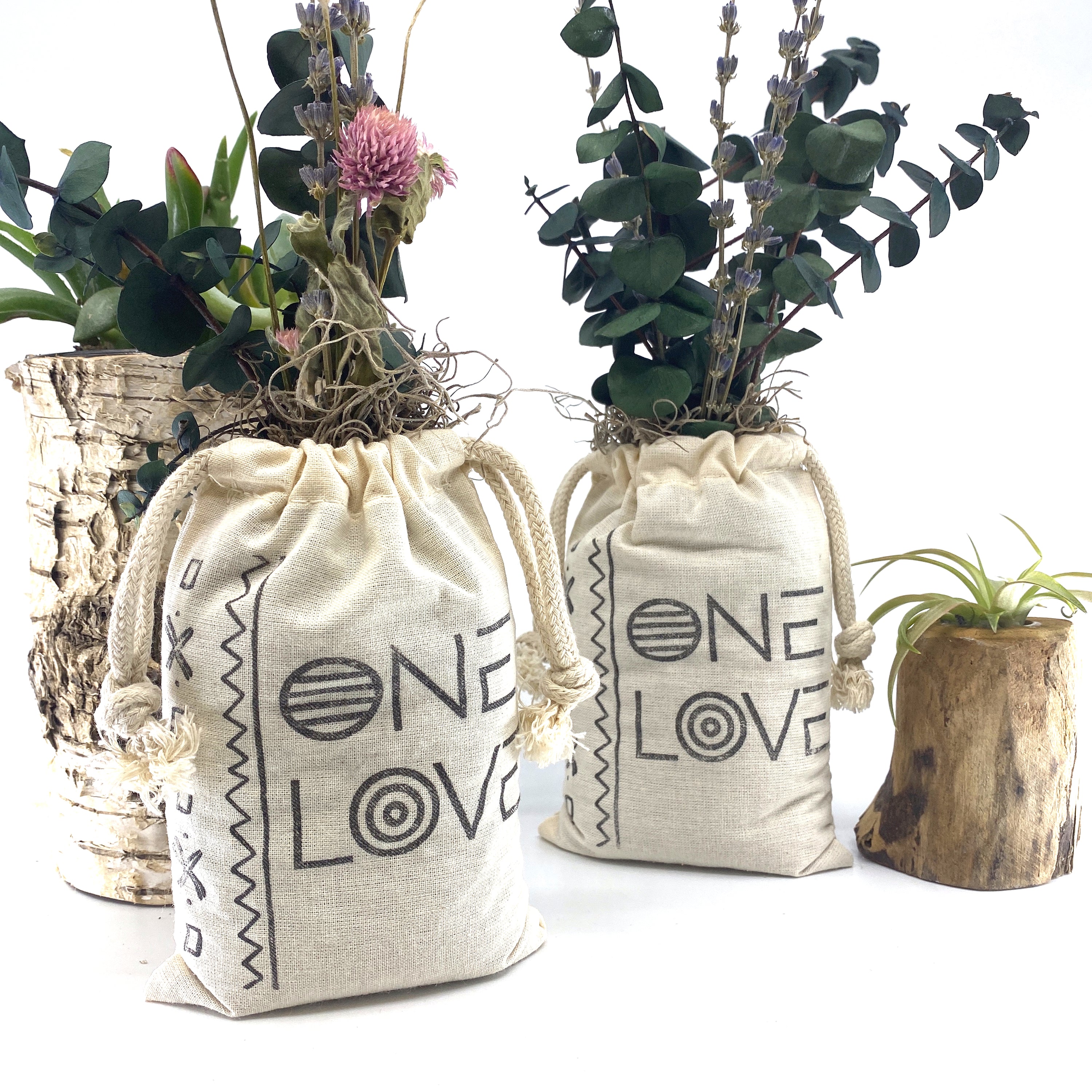 A beautifully arranged organic dried flower bouquet in a stylish sack, featuring lavender, eucalyptus, and accent flowers, topped with Spanish moss.
