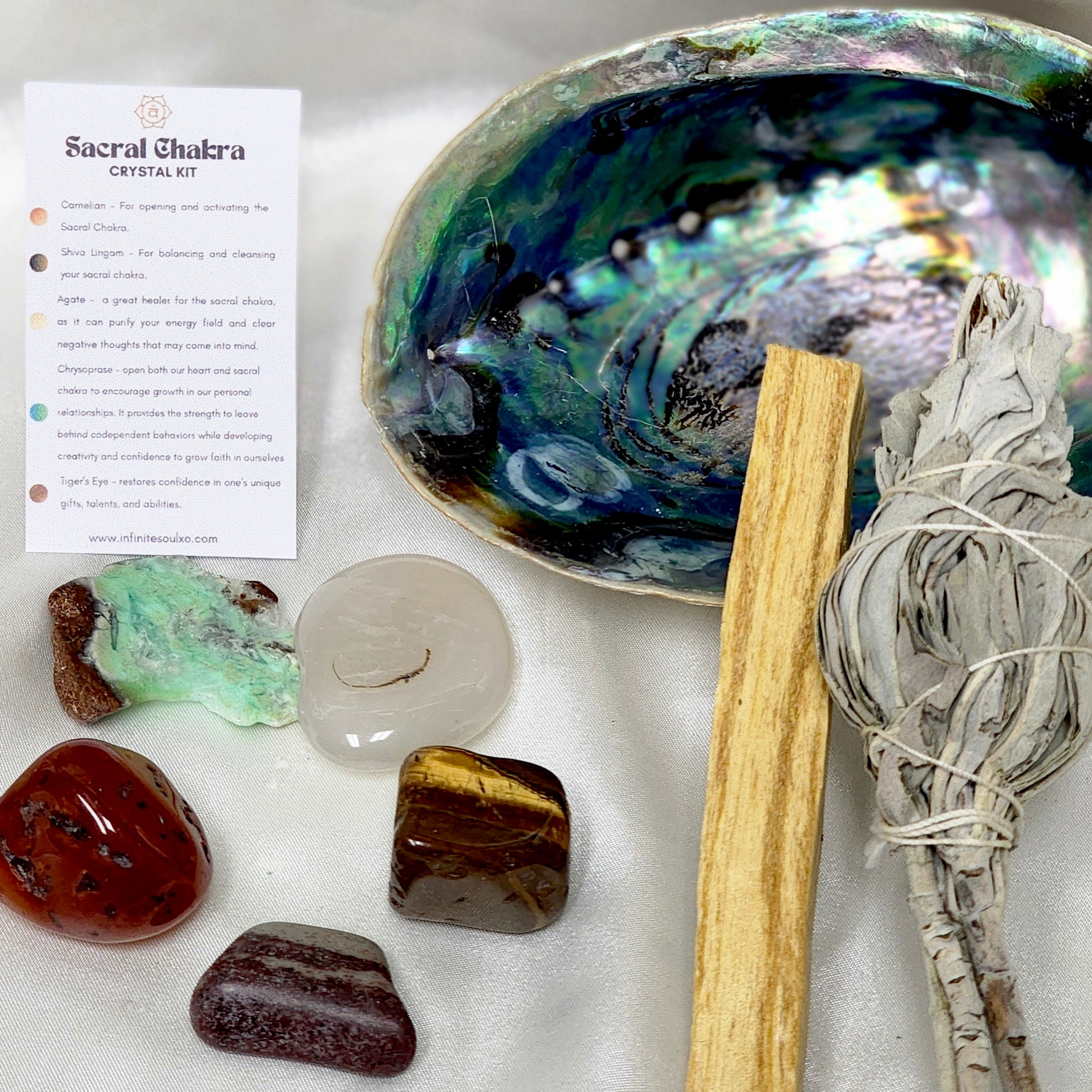 Sacral Chakra Smudge Kit featuring sage, palo santo, abalone shell, and various healing crystals for chakra alignment.
