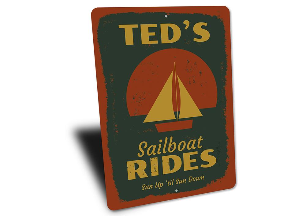 A decorative Sailboat Rides Sign made of high-quality aluminum, featuring a vibrant design perfect for lakehouse decor.