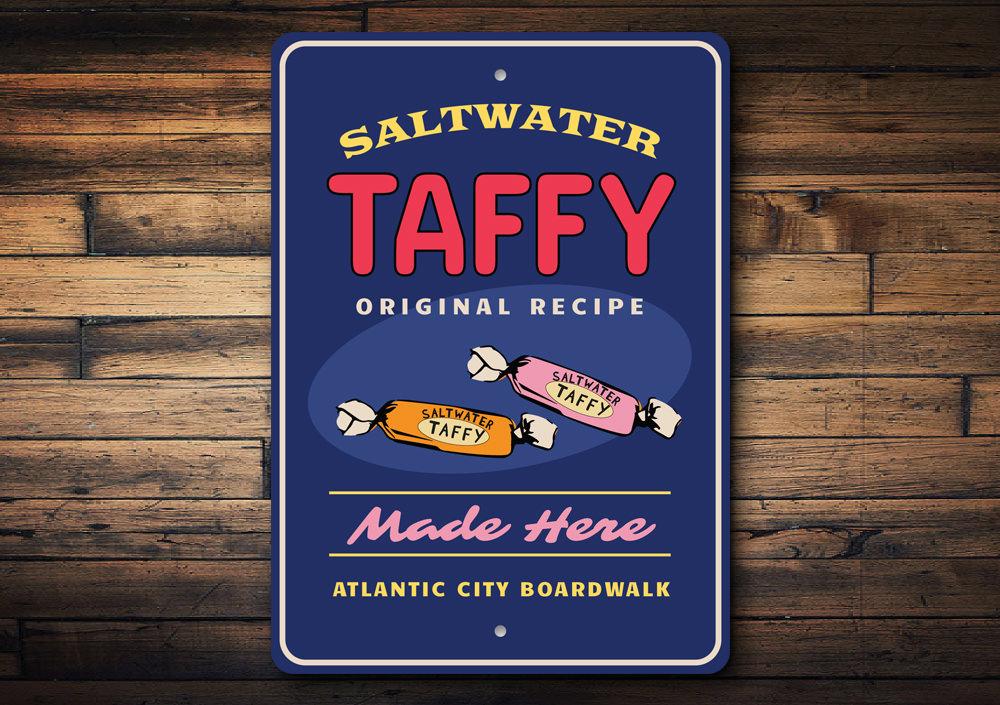 Saltwater Taffy Made Here decorative metal sign, featuring vibrant colors and a beach-themed design, perfect for coastal decor.