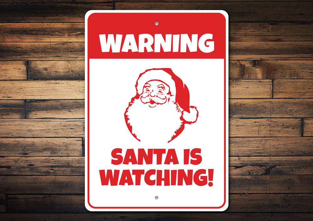A festive Santa is Watching Sign made of aluminum, featuring a charming design perfect for Christmas decorations.