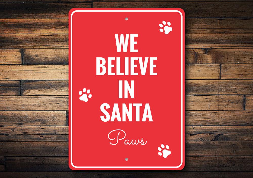 A festive Santa Paws Sign made of aluminum, featuring a cheerful design perfect for Christmas decorations.