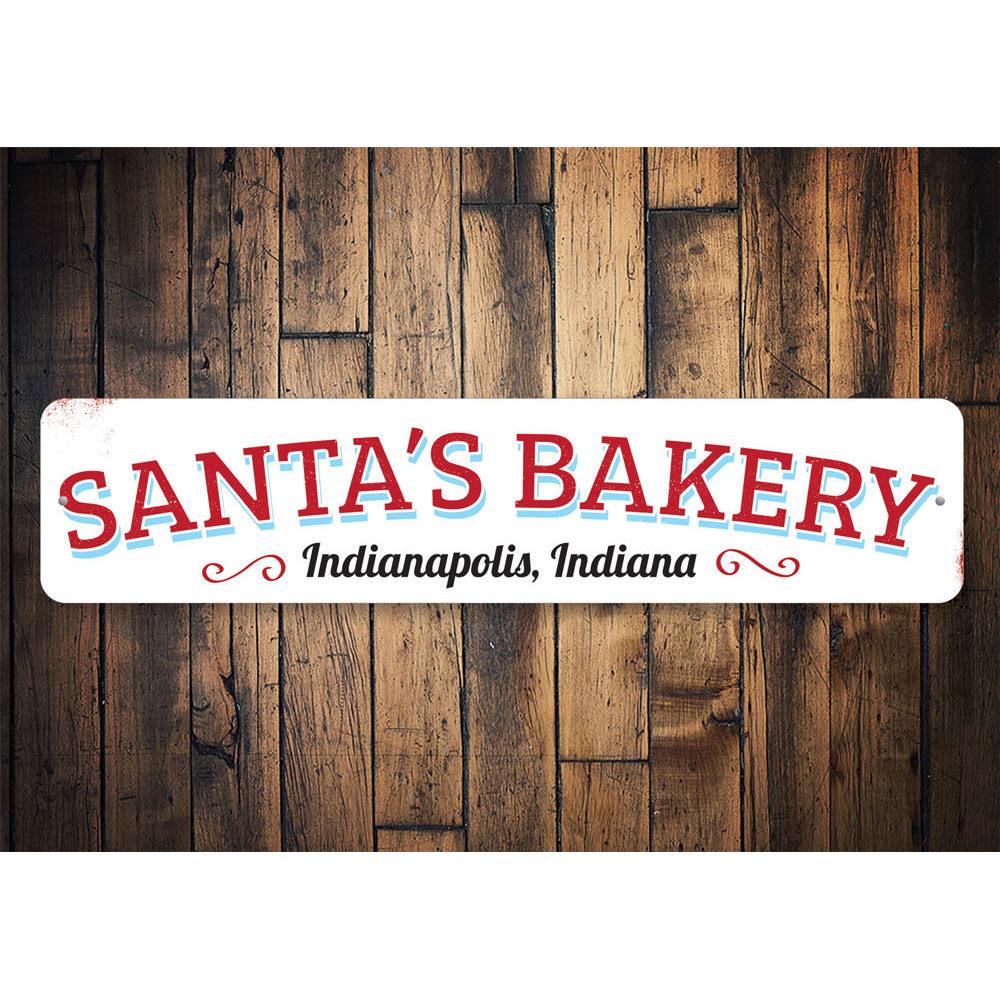 A festive Santa's Bakery Sign featuring cheerful holiday designs, perfect for Christmas decorations.