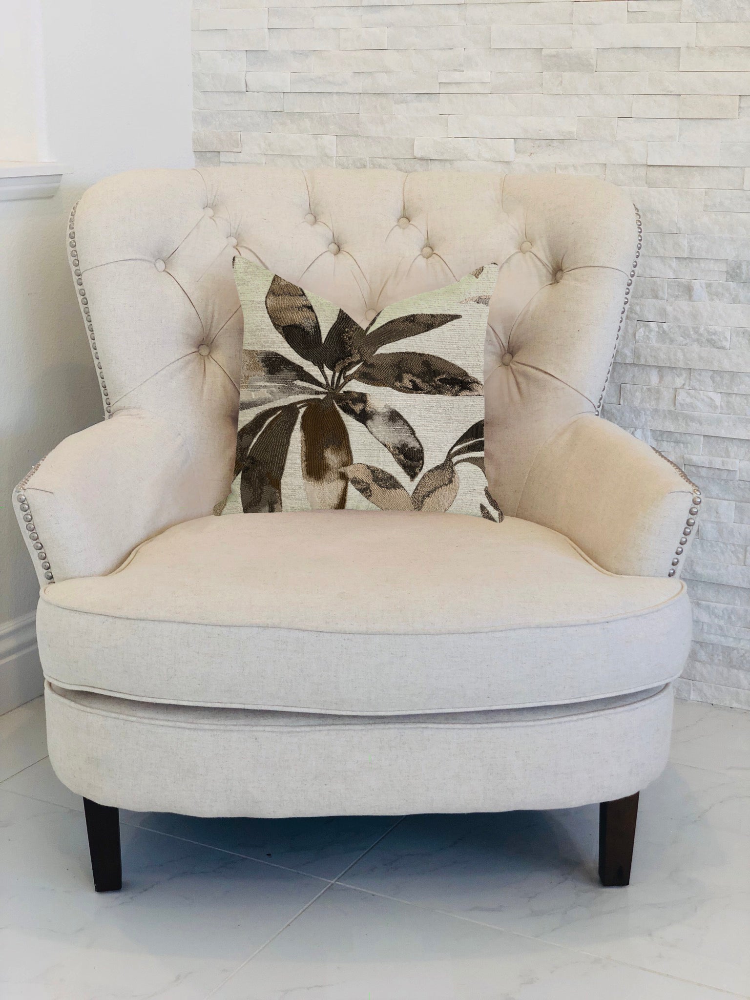 Santorini Cove luxury throw pillow in beige and brown tones, showcasing elegant design and quality craftsmanship.