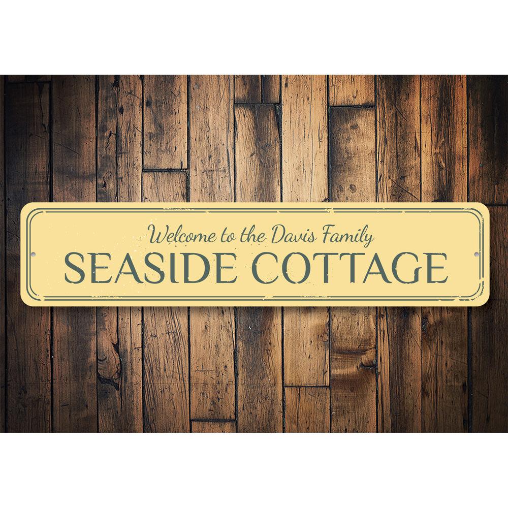 A beautifully crafted Seaside Cottage Sign made of aluminum, featuring coastal-themed designs, perfect for beach houses and outdoor decor.