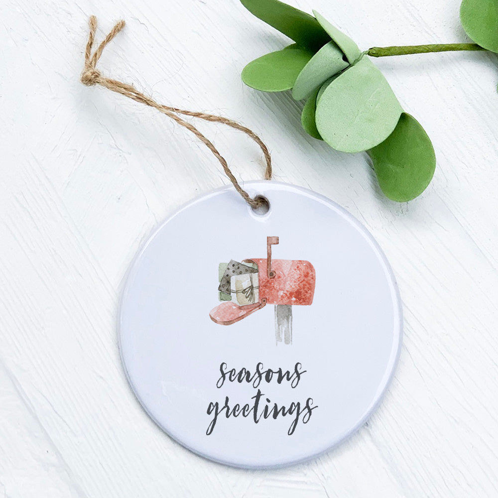 A beautifully crafted porcelain Season Greetings Mailbox ornament featuring vibrant colors and a glossy finish, perfect for holiday decor.