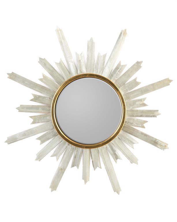 A stunning Selenite Starburst Mirror with a gold frame, radiating outward in a starburst pattern, reflecting a clear image.
