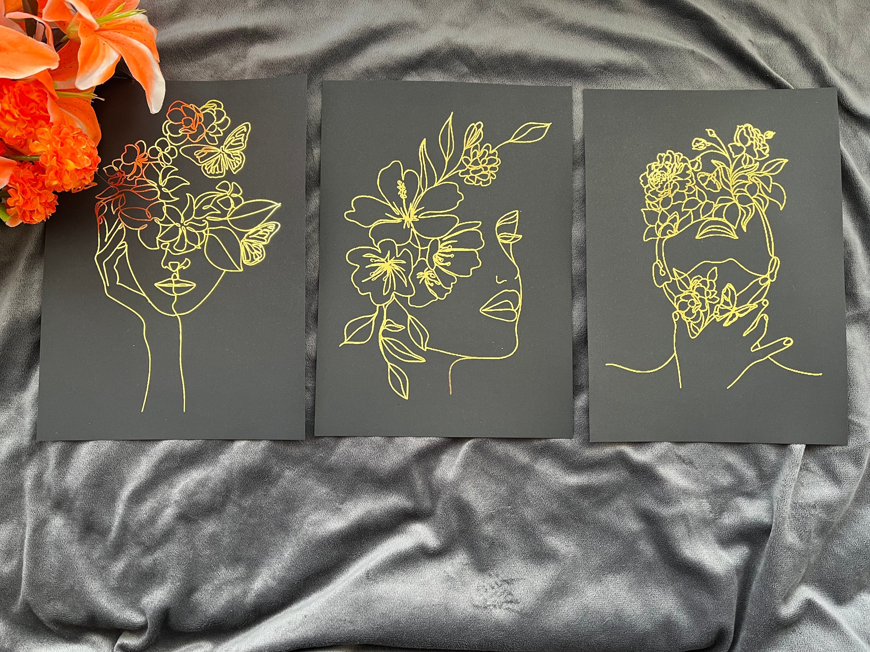 Set of 3 elegant foil prints featuring one line drawings of women's faces in black and gold, showcasing minimalist art style.