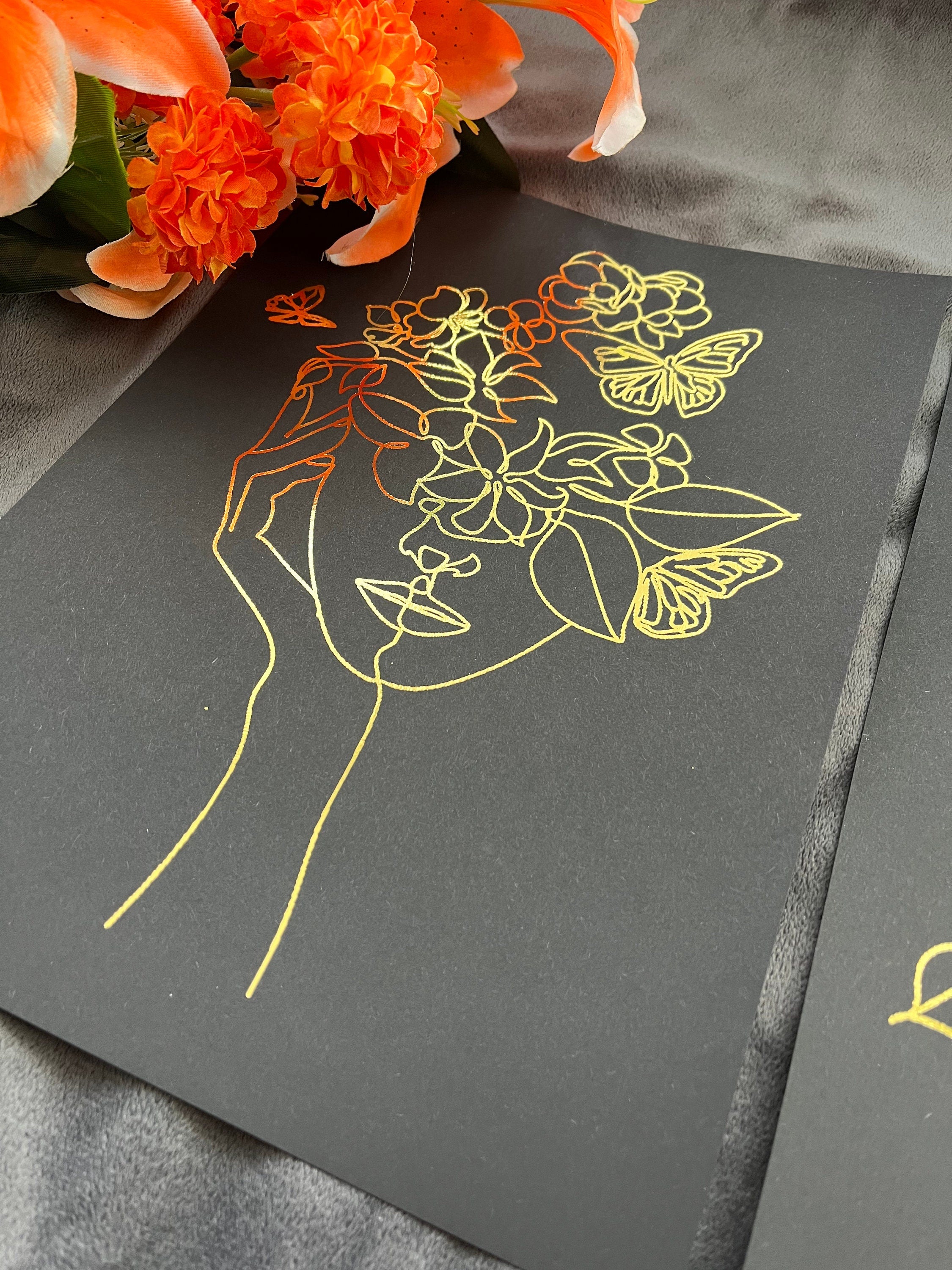 Set of 3 elegant foil prints featuring one line drawings of women's faces in black and gold, showcasing minimalist art style.
